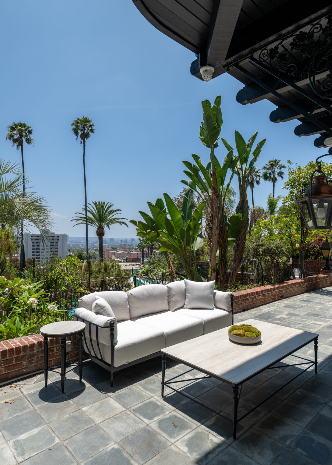 An outdoor lounge atop concrete tiles.