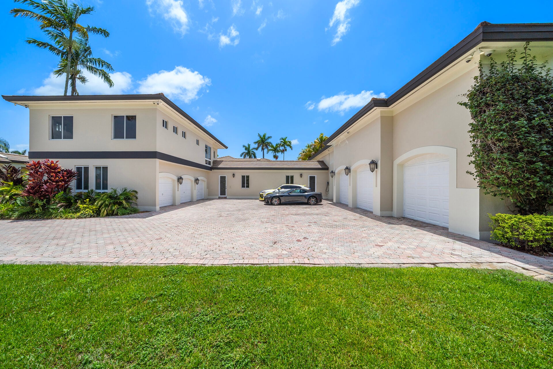 Passing through the estate's double gates, the property opens to a motor court framed by two wings of climate-controlled garages.