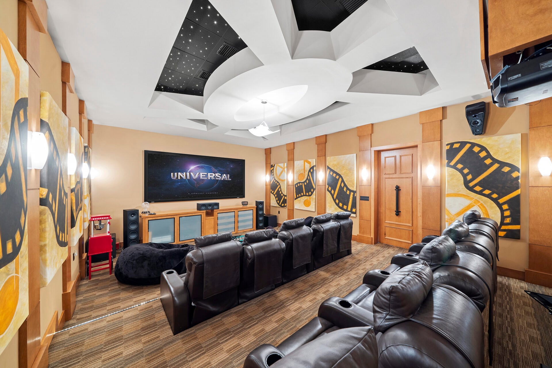 The private 11-seat theater is designed with two rows of reclining leather seating facing a large screen and a full surround sound system. 