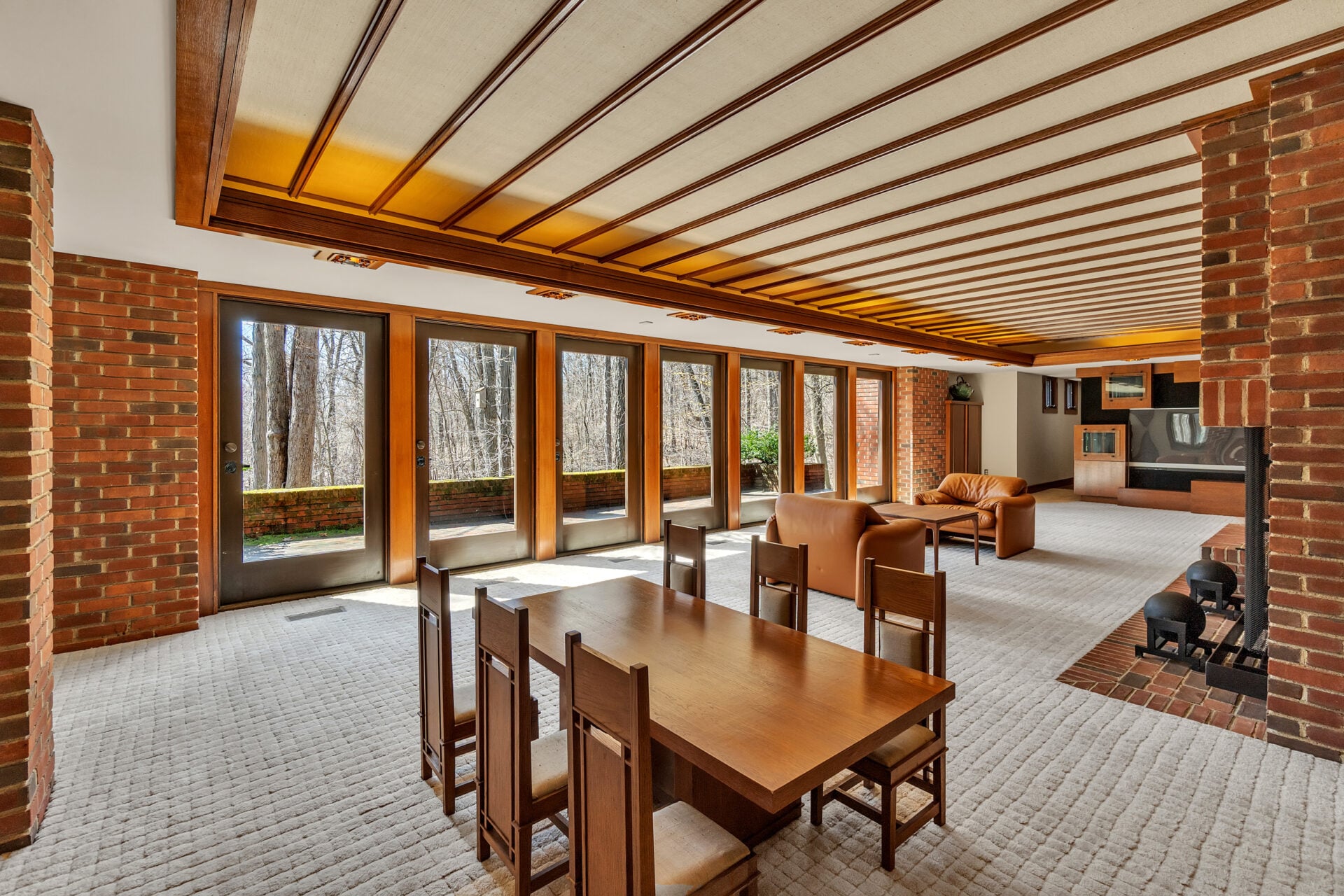 The lower level offers additional living spaces, including a full living room with glass doors that open directly to the outdoors.