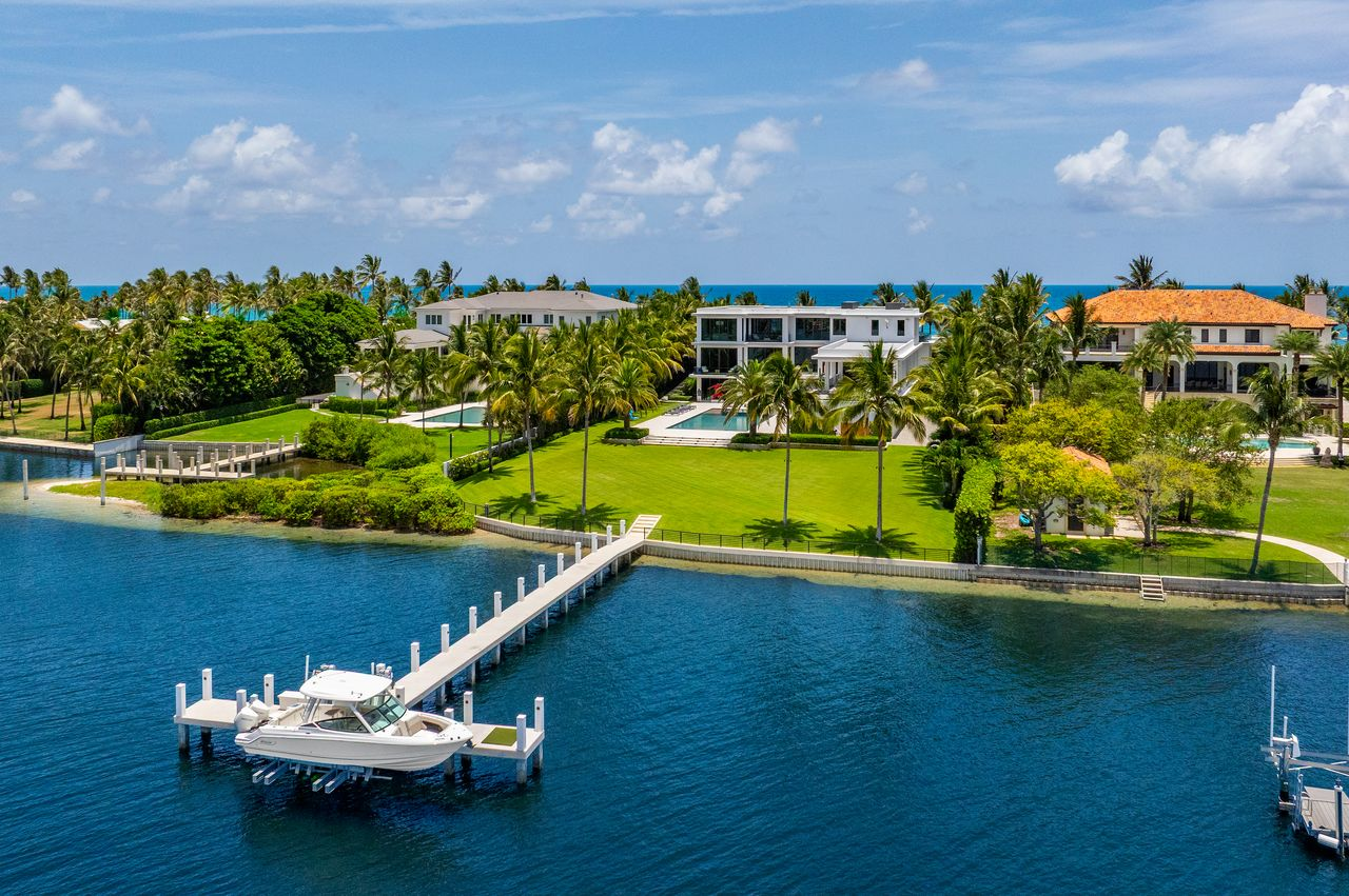 On the Intracoastal side of the property, a private concrete dock with a boat lift provides quick access to open water.