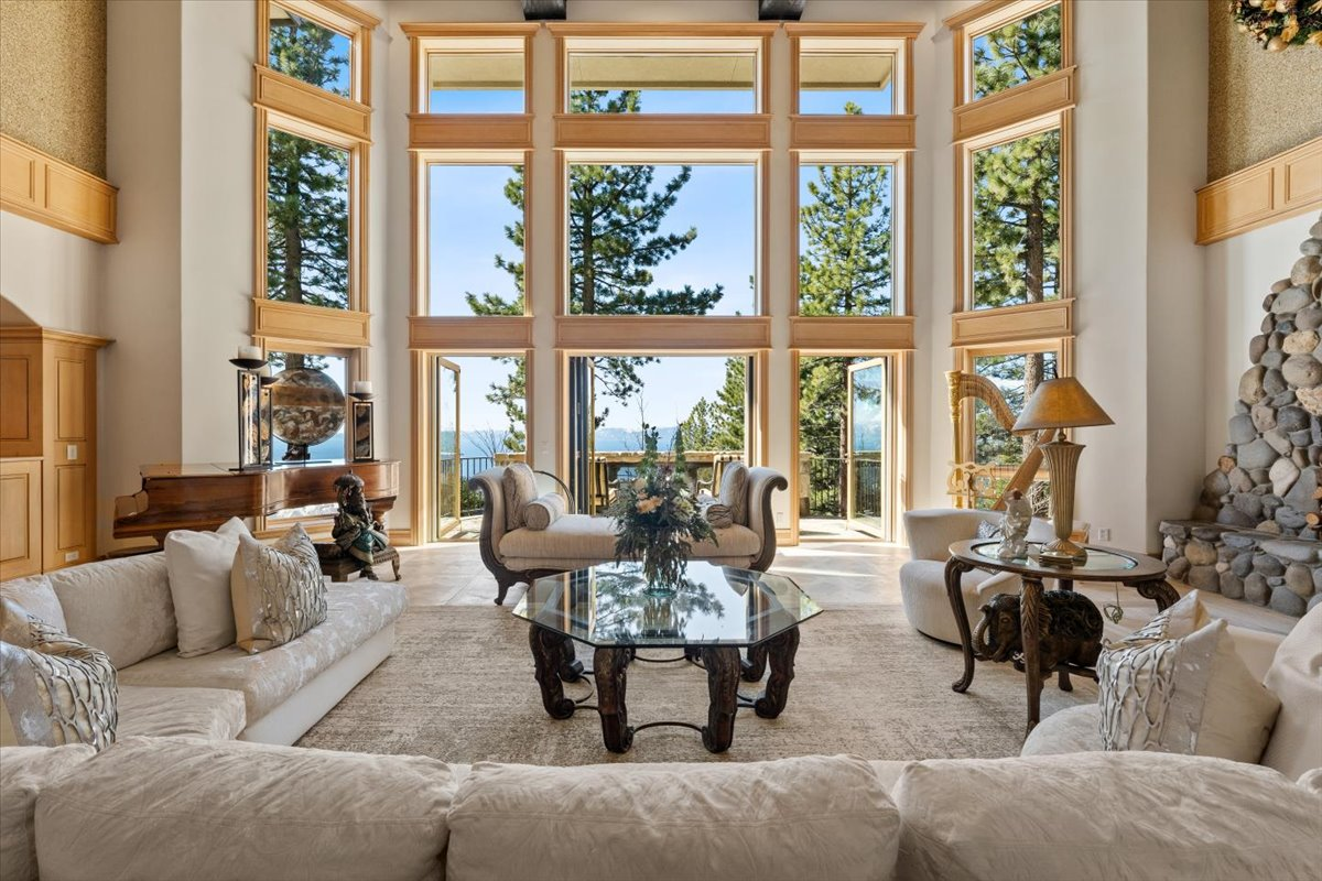 Floor-to-ceiling glass walls frame panoramic views of the lake and the Sierra Nevada from nearly every angle
