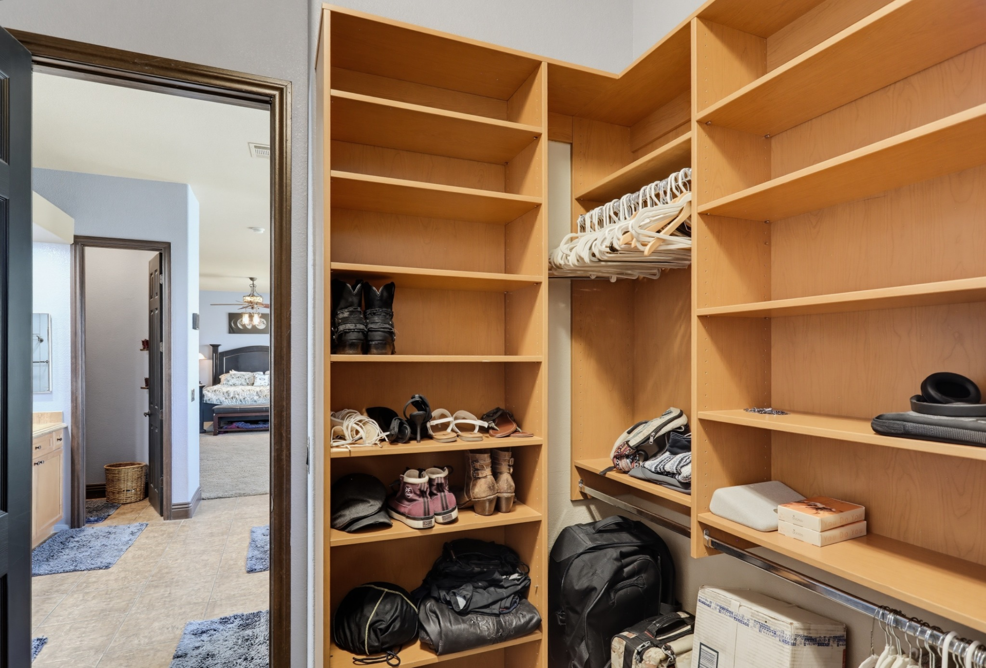 A second walk-in closet is located past the bathroom, providing another dedicated dressing and storage space. 