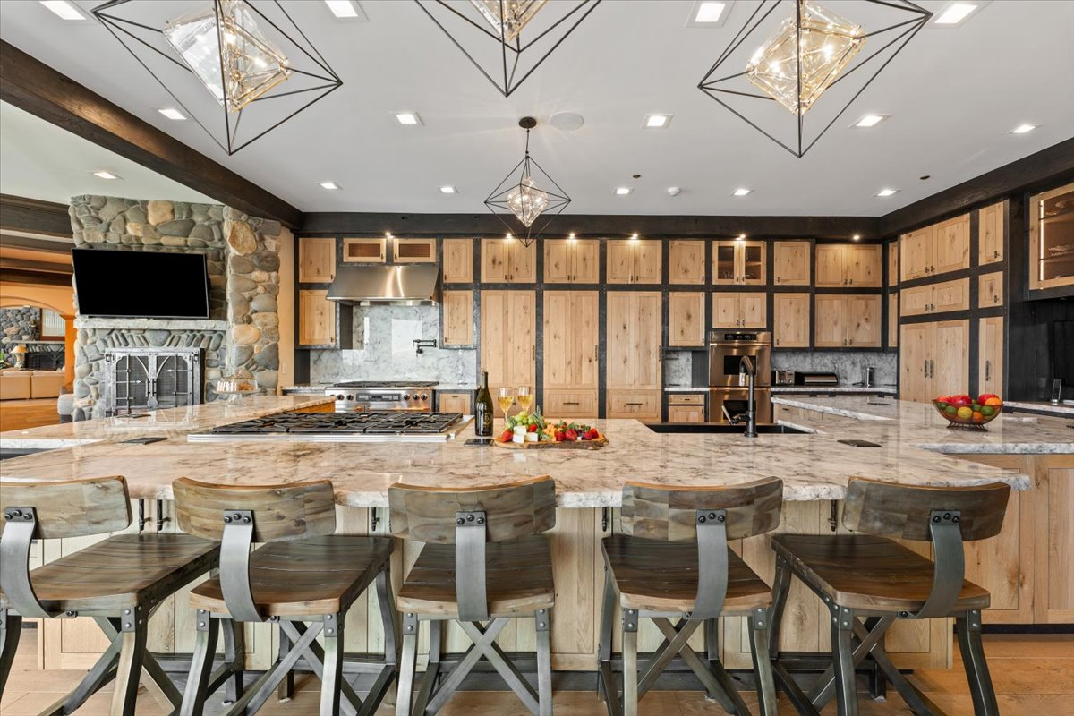 Natural oak cabinetry framed by dark timber accents stretches from floor to ceiling.