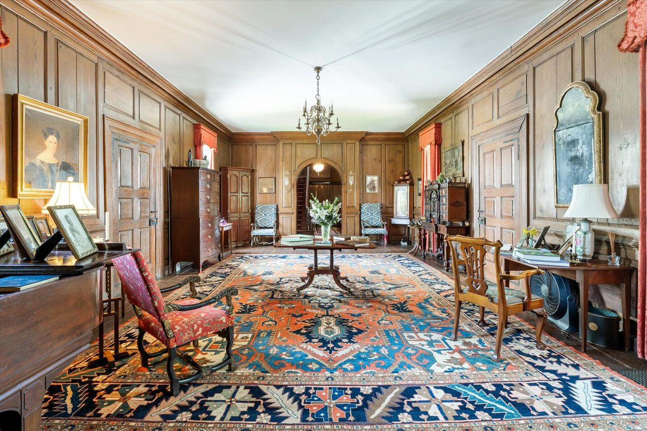 A large central hall that serves as the home's main crossroads, with paneled doorways leading to each of the main living spaces.