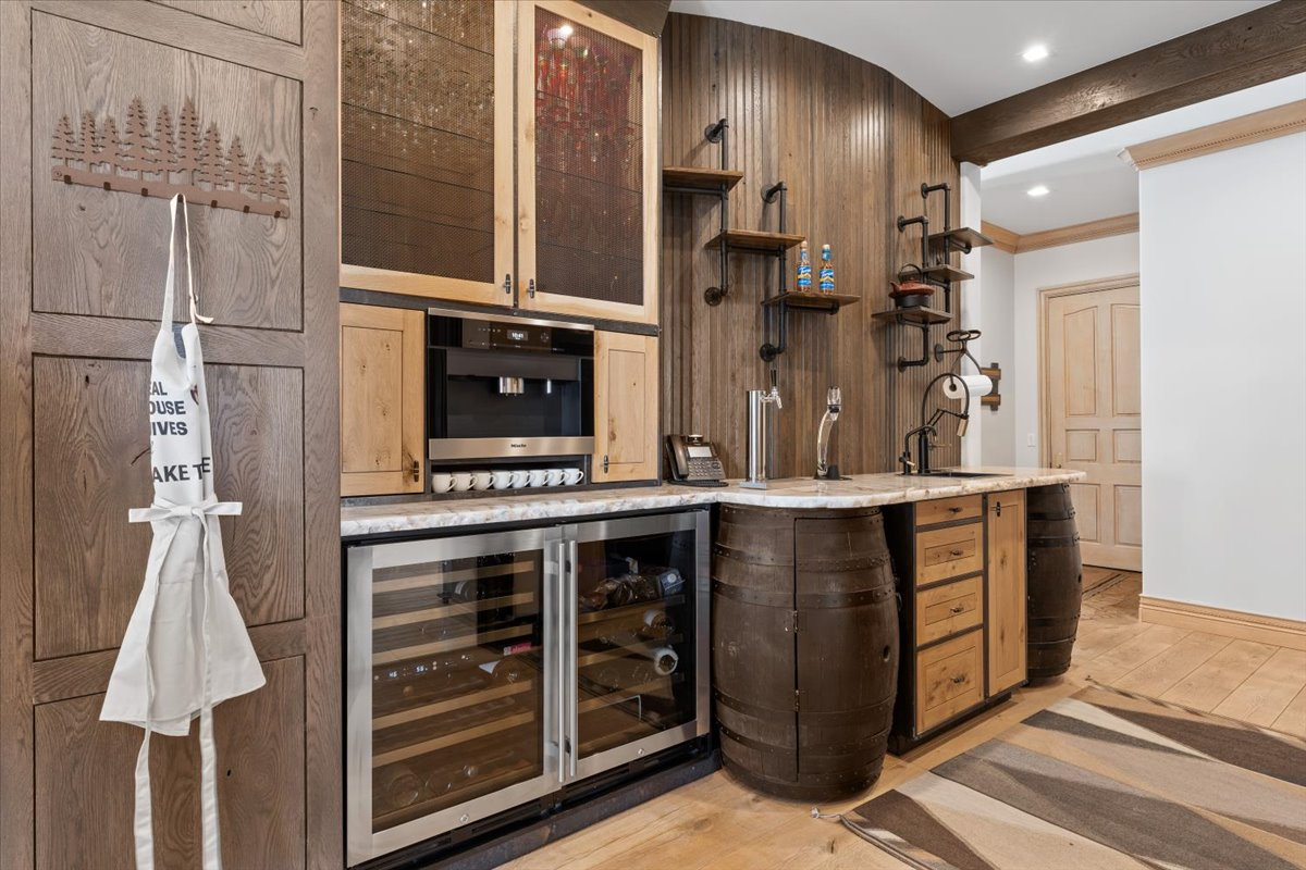 A dedicated coffee bar finishes off the kitchen with a built-in Miele coffee station, refrigerated drawers, wine storage, and additional prep space