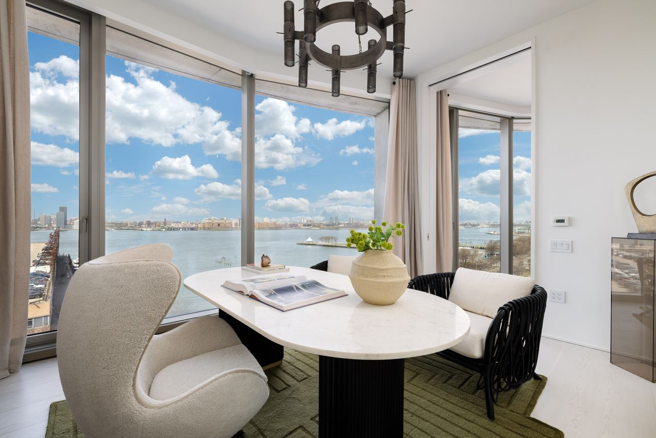 A bedroom off the great room is currently arranged as a bright home office, taking full advantage of the penthouse's views. 
