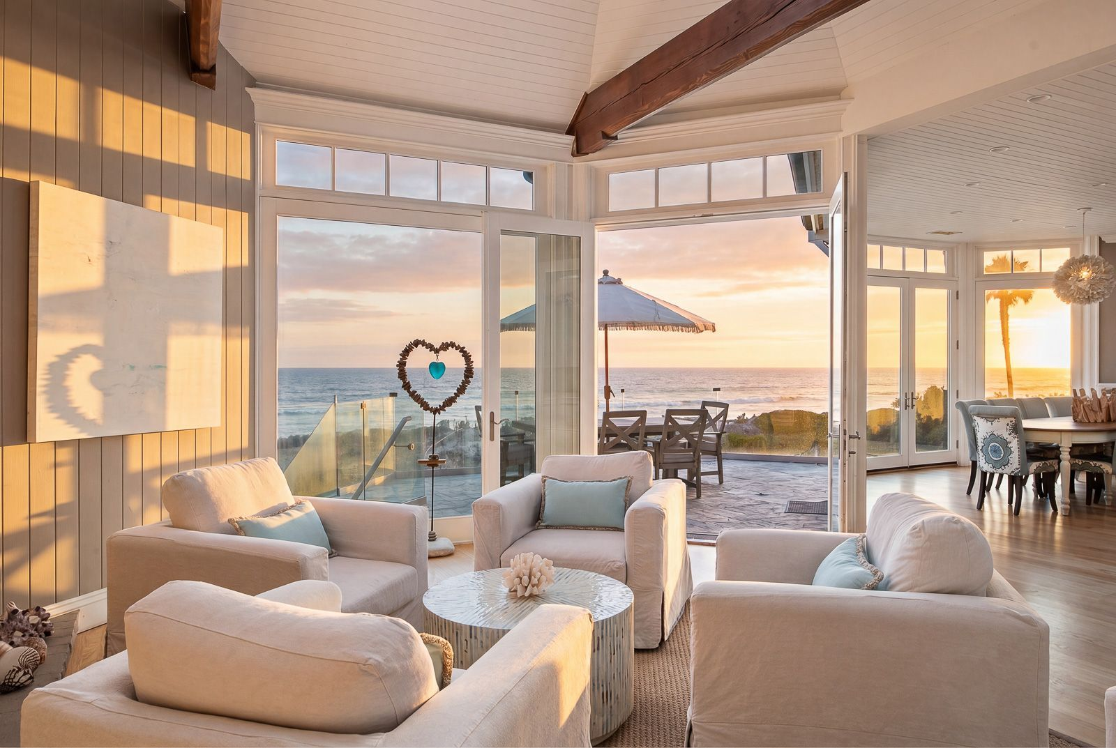 A second seating area sits closer to the French doors, creating a quieter place to take in the coastline as the indoor living spaces transition onto the oceanfront terrace.