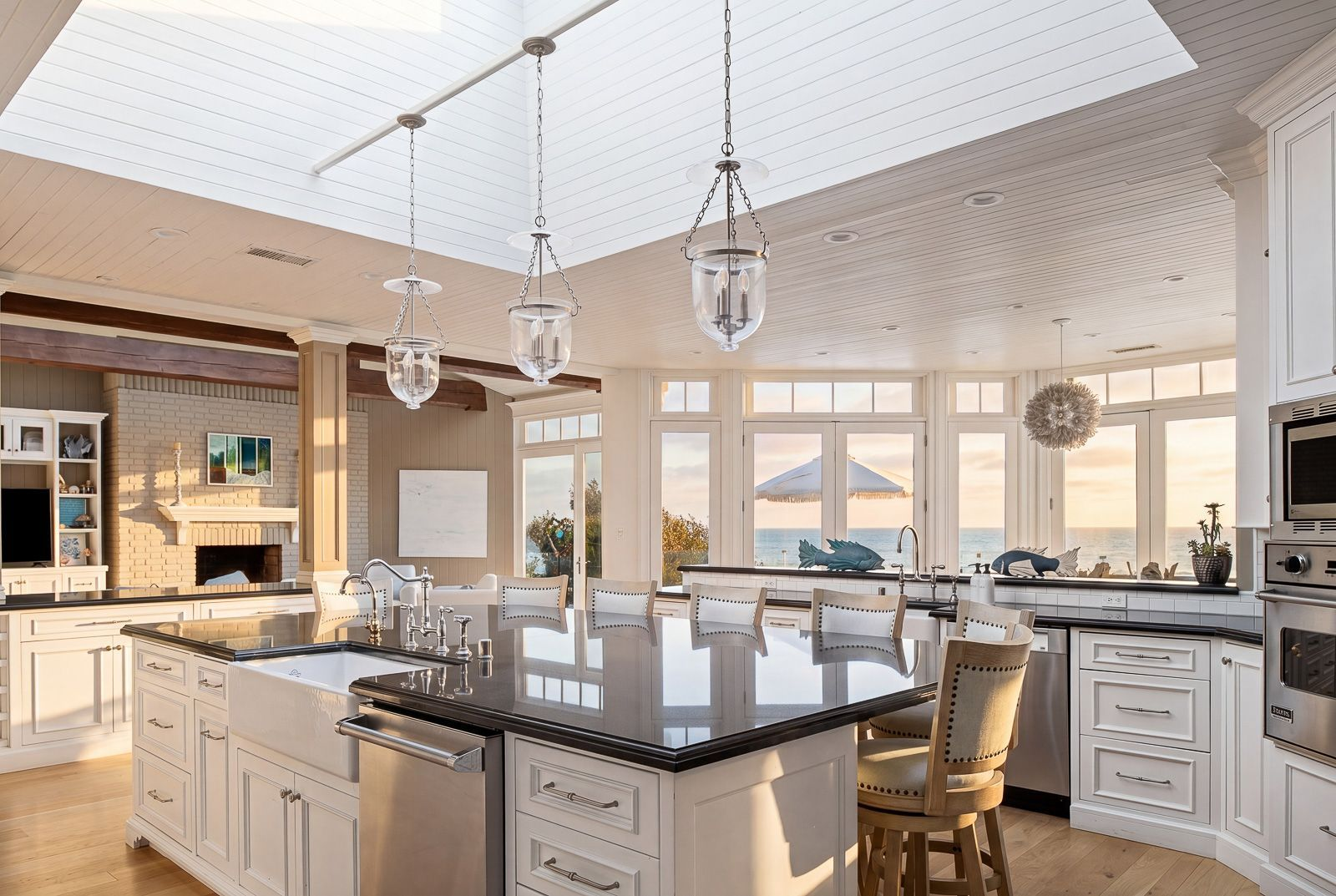 The kitchen is fully equipped with Viking appliances, three ovens, two dishwashers, and counter seating.