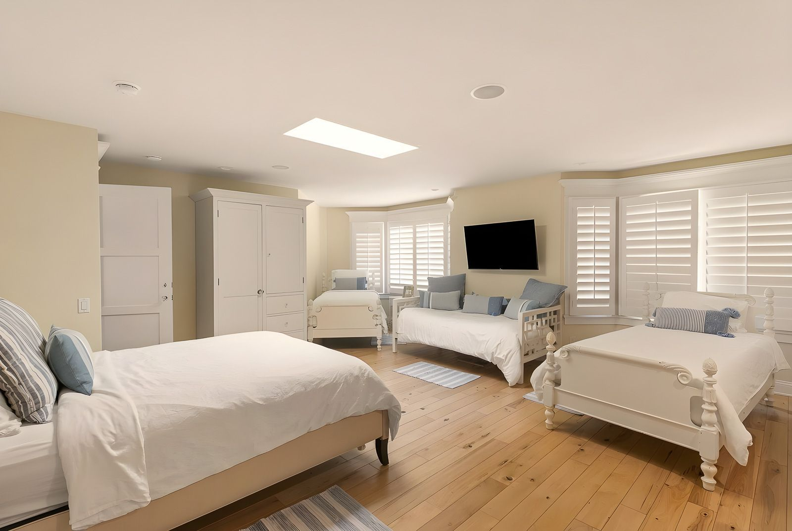 The spacious bedroom easily accommodates multiple sleeping arrangements, with enough room for several beds and wardrobes.