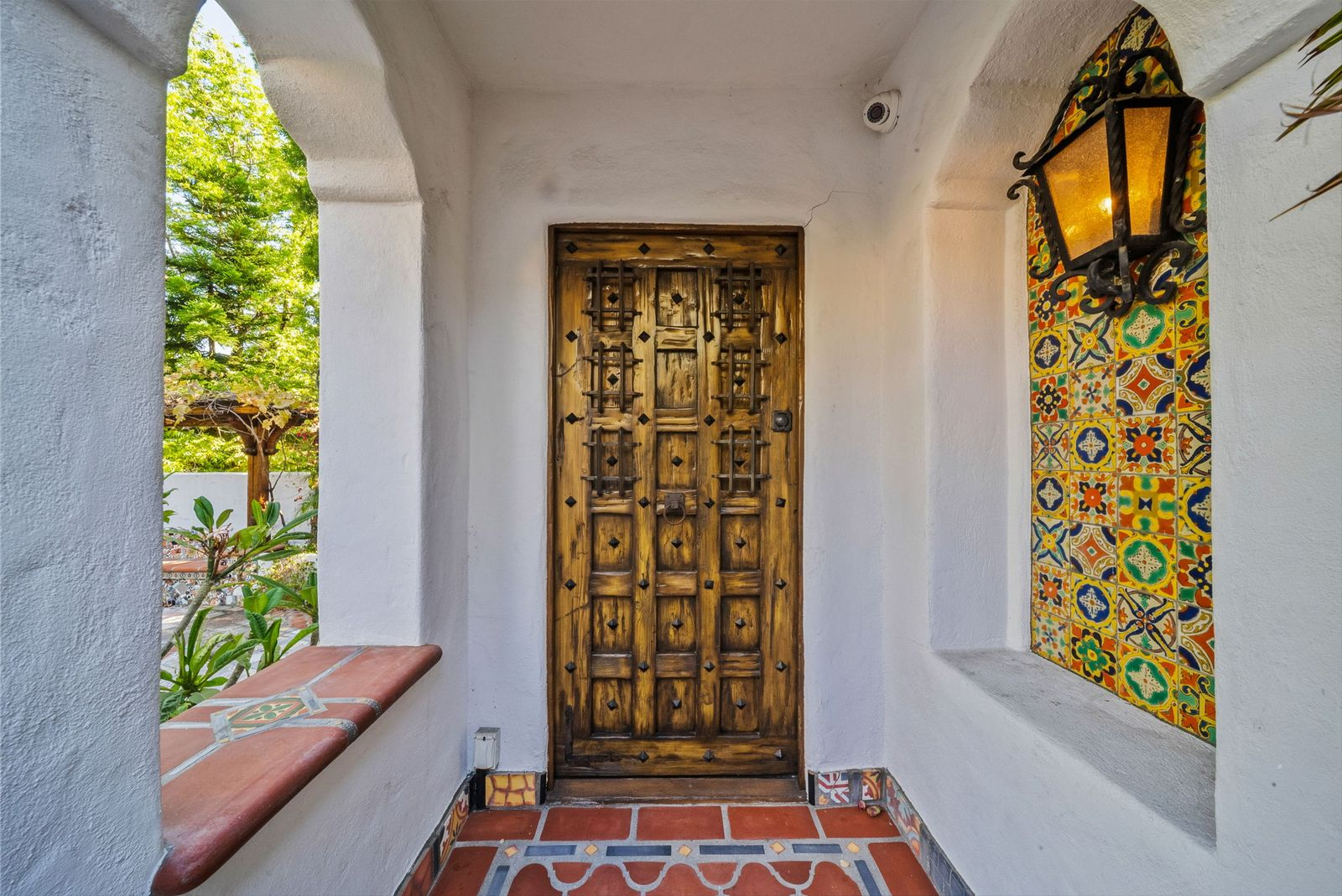 At the covered front entry, a hand-carved front door was salvaged from an 800-year-old temple in Afghanistan.