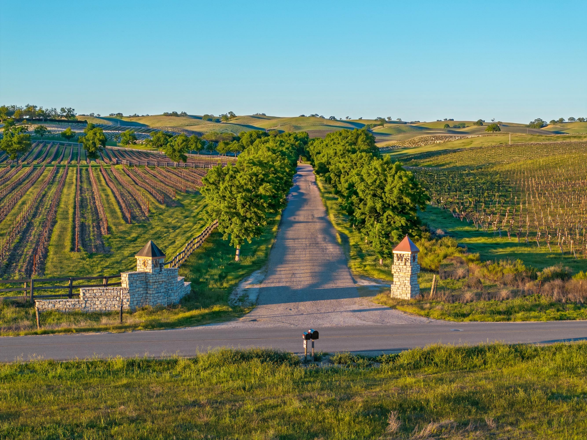The entrance to Alex Trebek’s former California vineyard down a long concrete drievway.