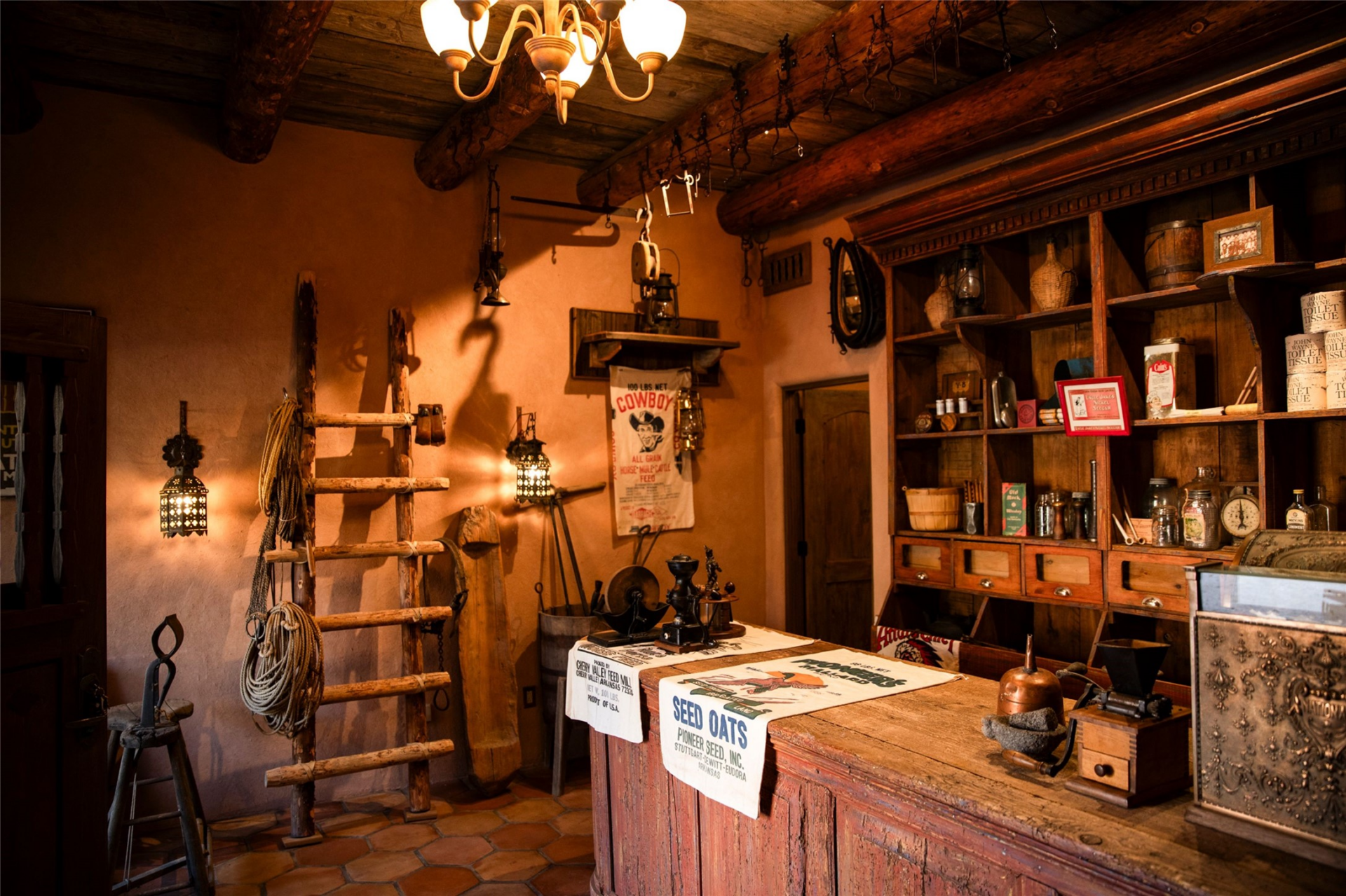 The general store completes our highlights of this Western streetscape with a long wood counter, vintage cash register, open shelving, and period-style merchandise.