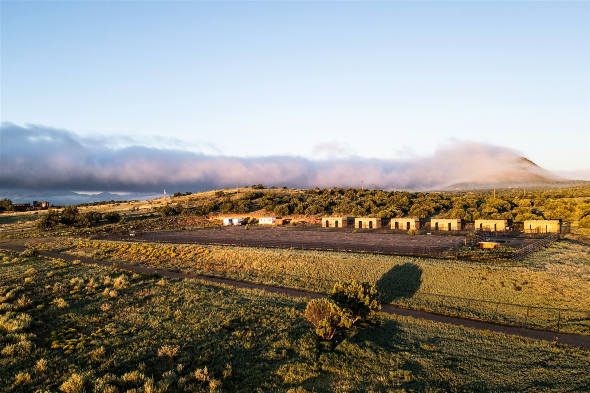 The equestrian facilities spread across multiple pastures and a large riding arena.