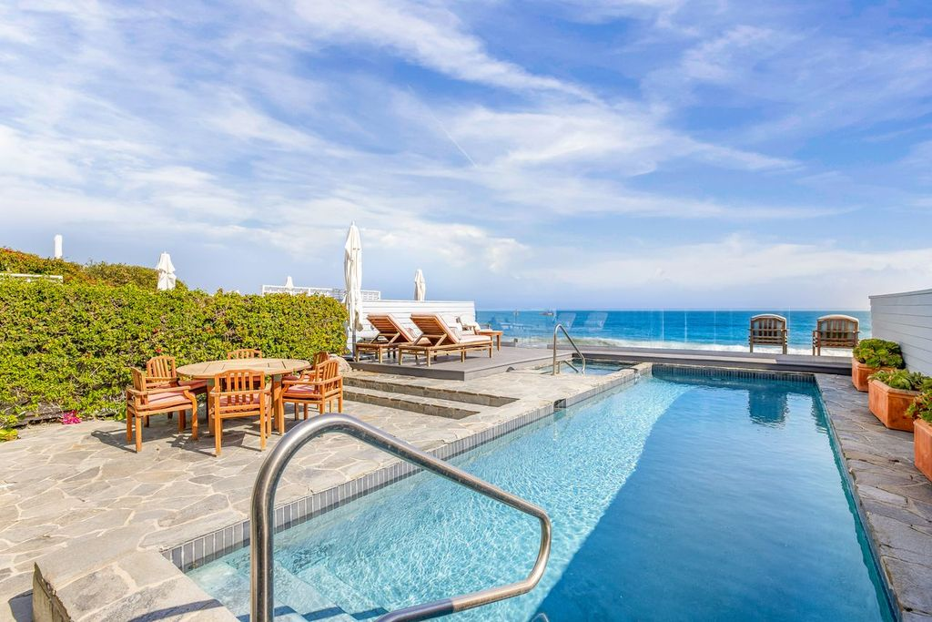 Beachfront terrace that extends directly from the house to a private swimming pool and raised spa set only steps from the sand. 