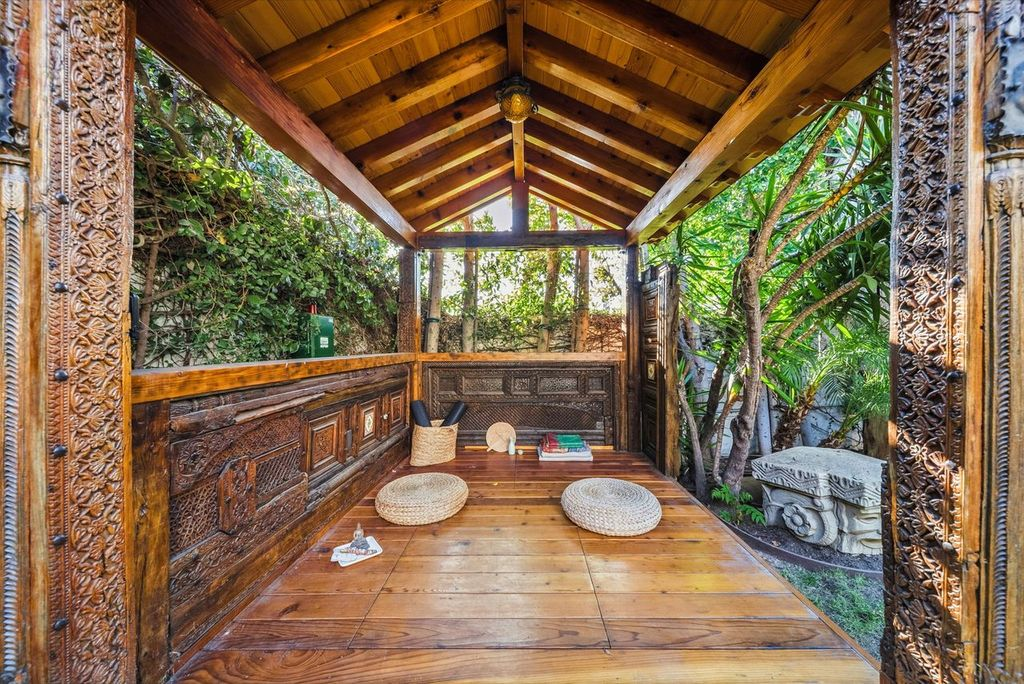 Carved wooden cabana designed as a quiet space for yoga or meditation.