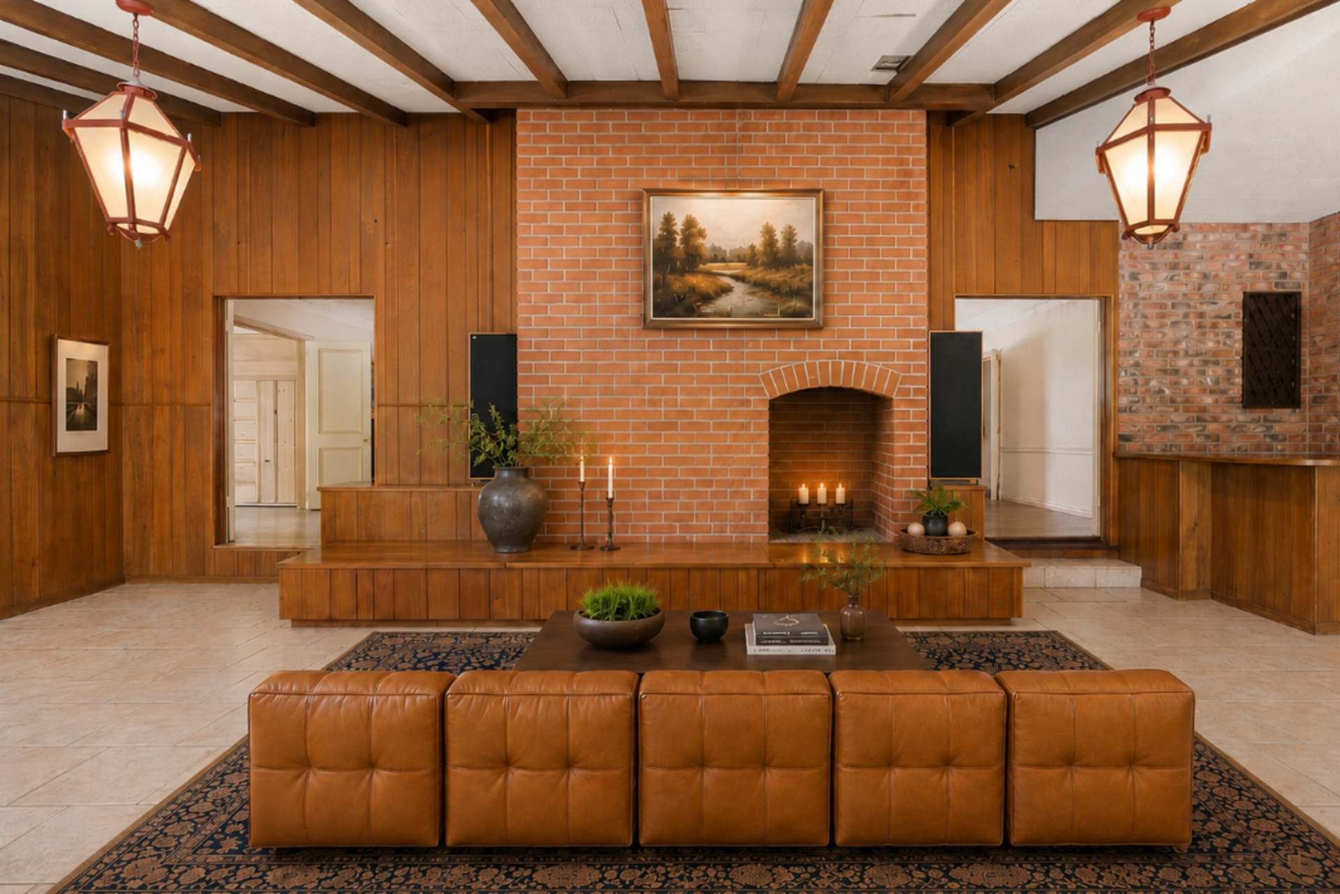 A brick fireplace, bar, and small seating area line one side of the room.