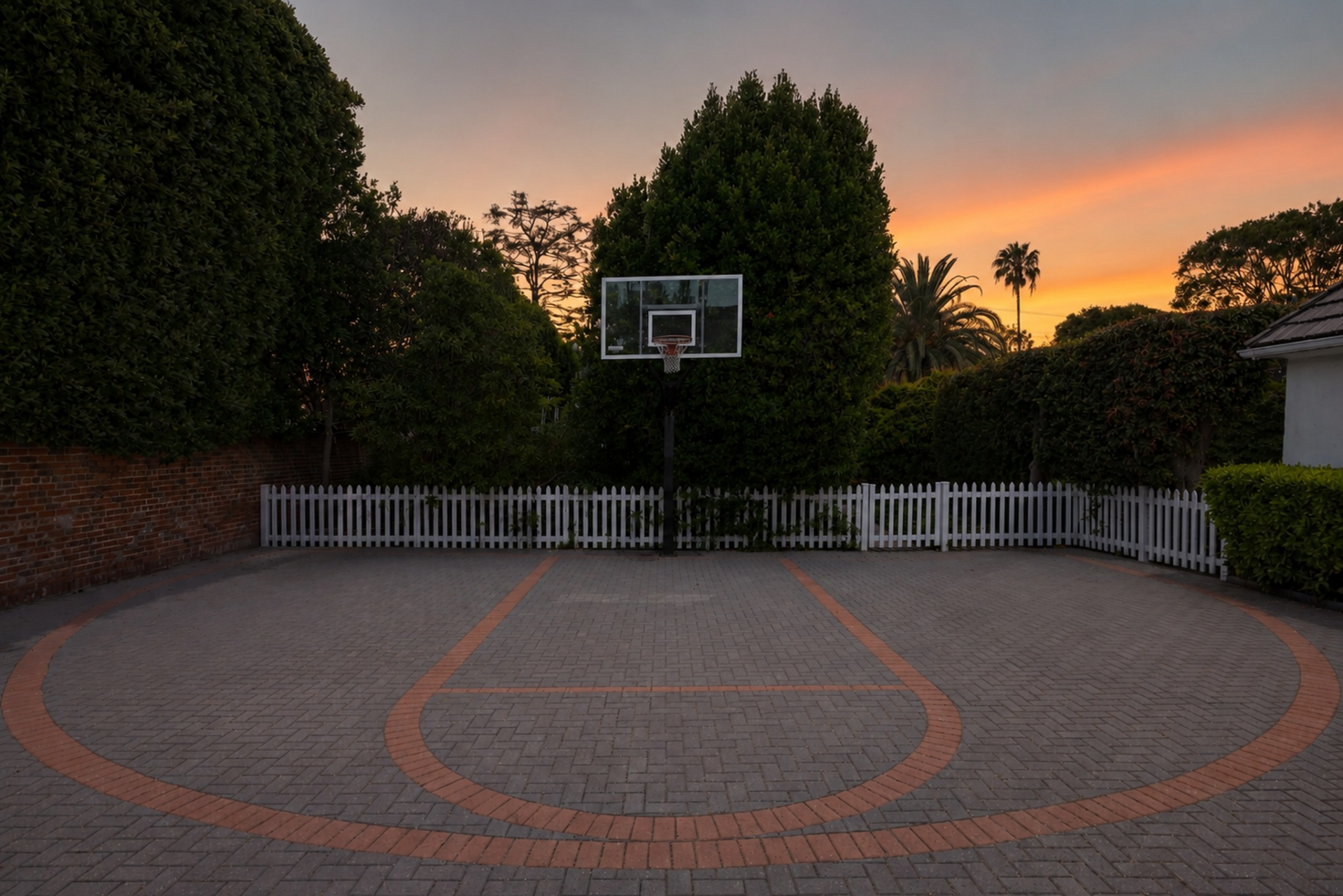 Around the corner near the garages, a paved half basketball court completes the outdoor amenities.