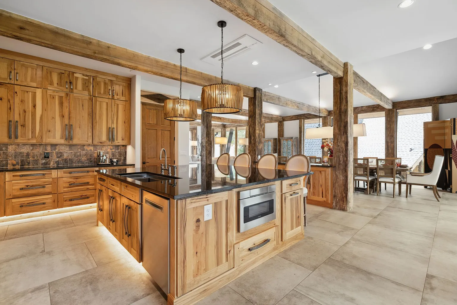 A large island provides seating for four beneath woven pendant lights