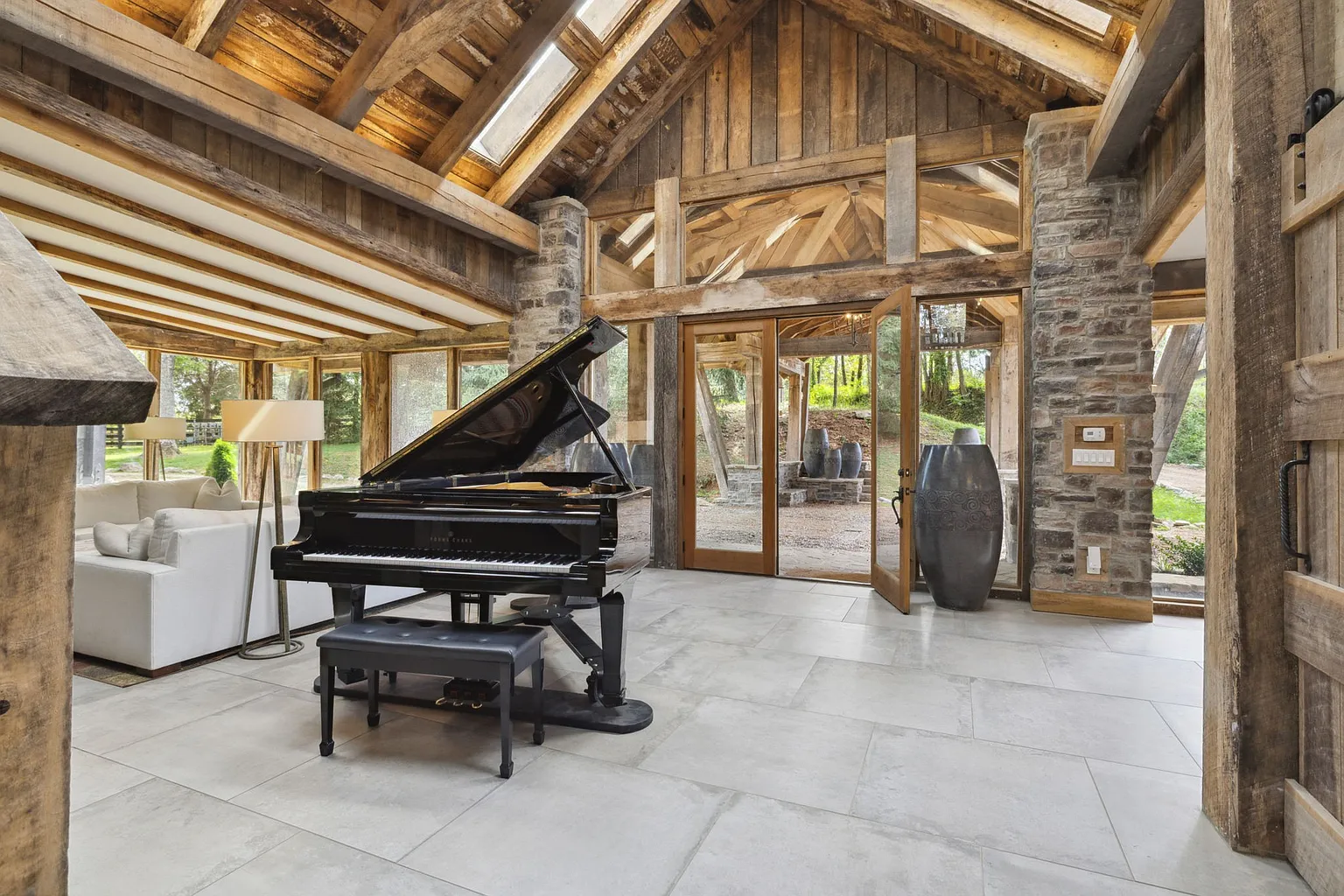 Bright contemporary living areas with soaring timber-framed ceilings, walls of glass, and a grand piano.