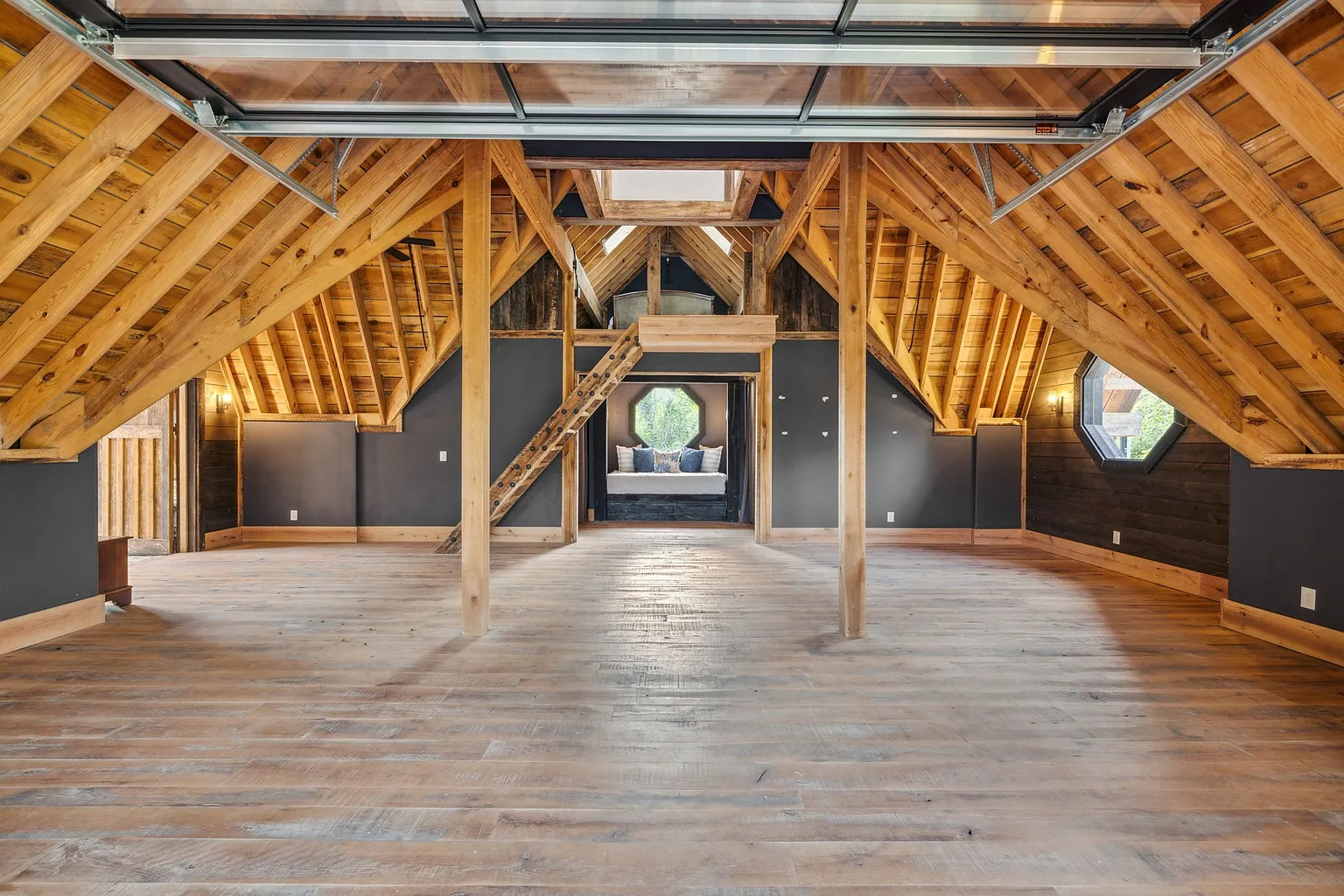 The timber-framed structure features soaring vaulted ceilings with exposed trusses, and an expansive open floor plan.