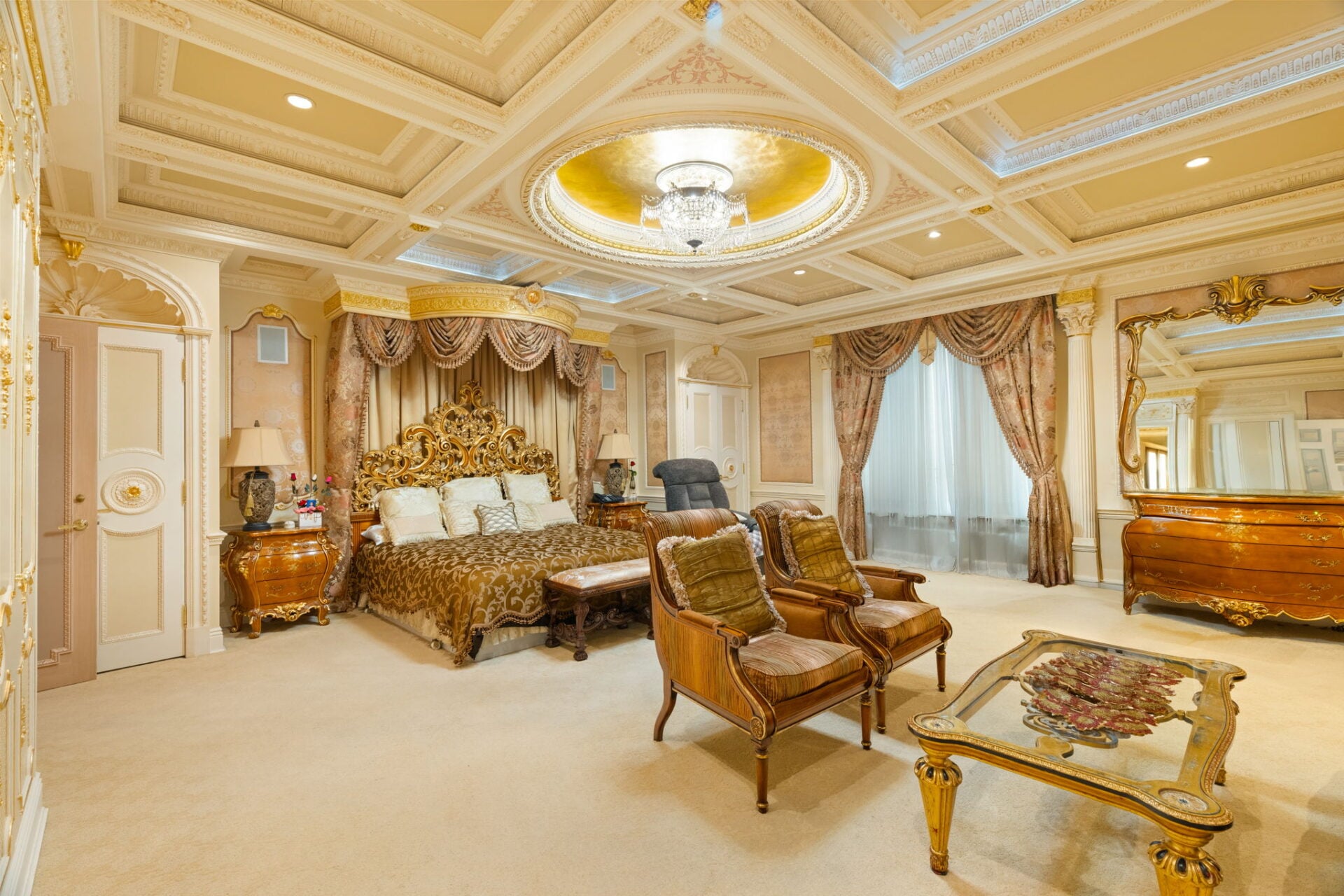 The room has so many design details to take in, from the paneled walls and heavy drapery to the carved furniture.