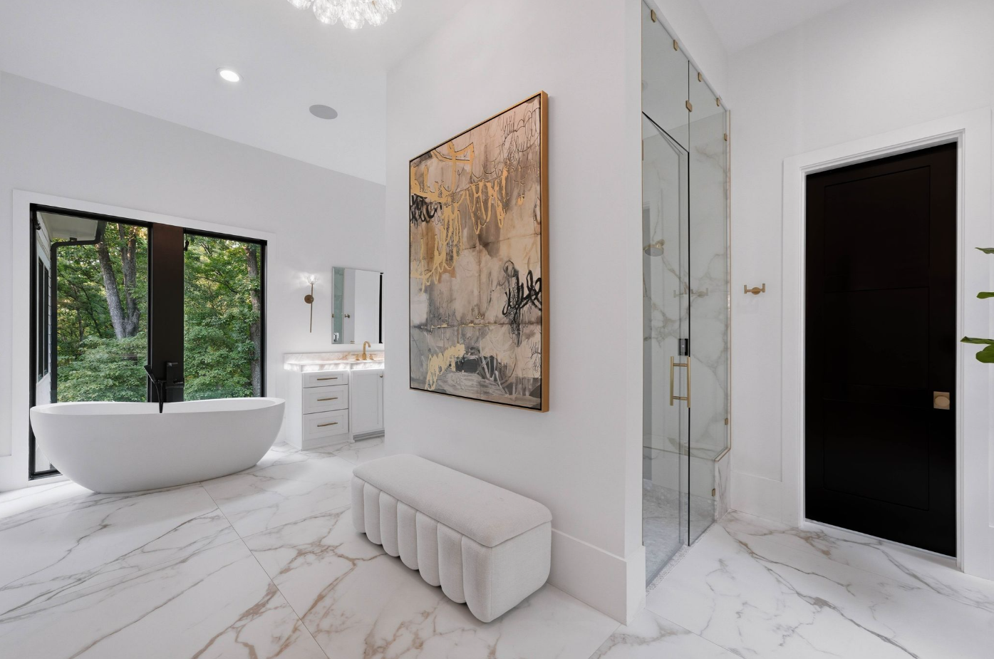 The connected bathroom opens across marble flooring with an oversized glass-enclosed rain shower sitting in the middle between two separate water closets.