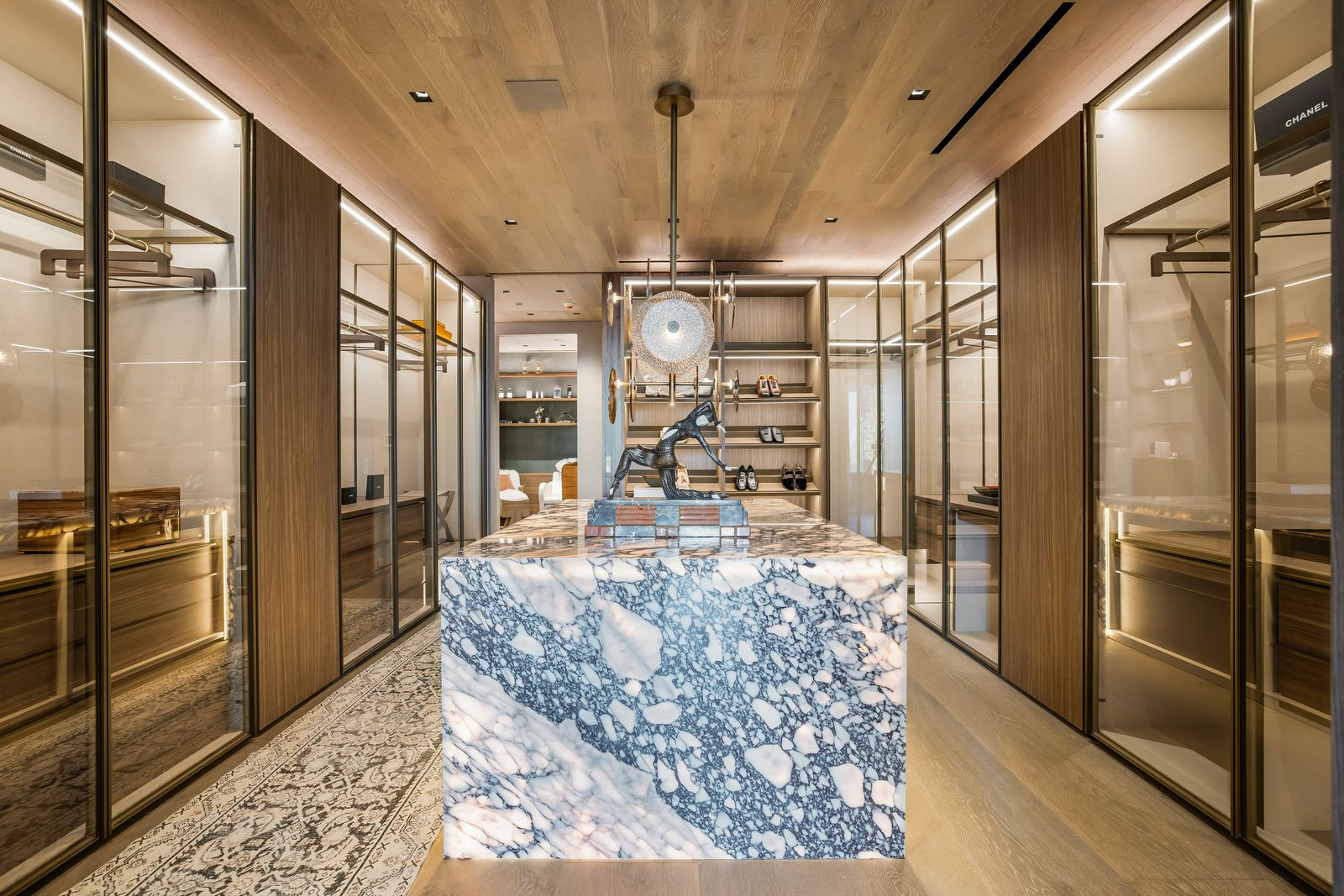 Each closet is organized around a large stone island, including one with dramatically veined stone.
