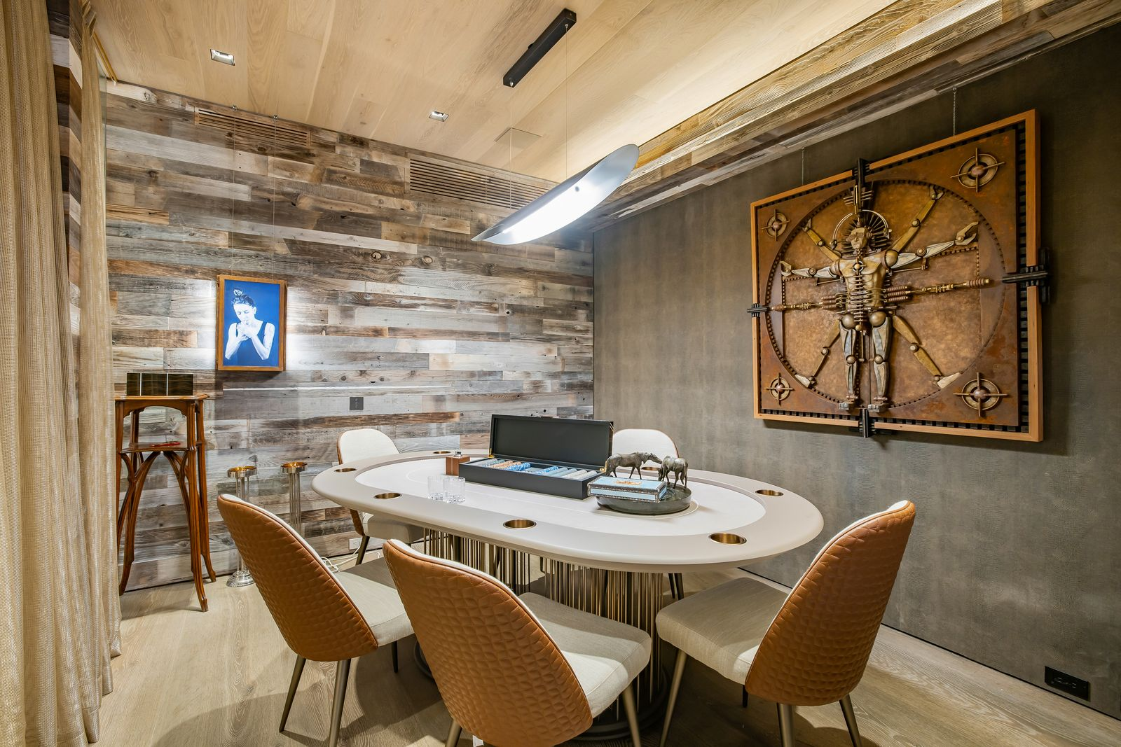 The poker room is a smaller, enclosed space built around a single oval gaming table.