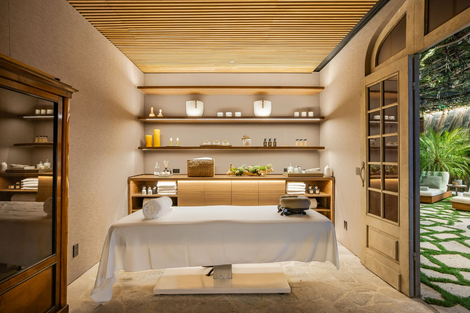 A separate treatment room connects directly to the space and is set up for massage and other treatments.