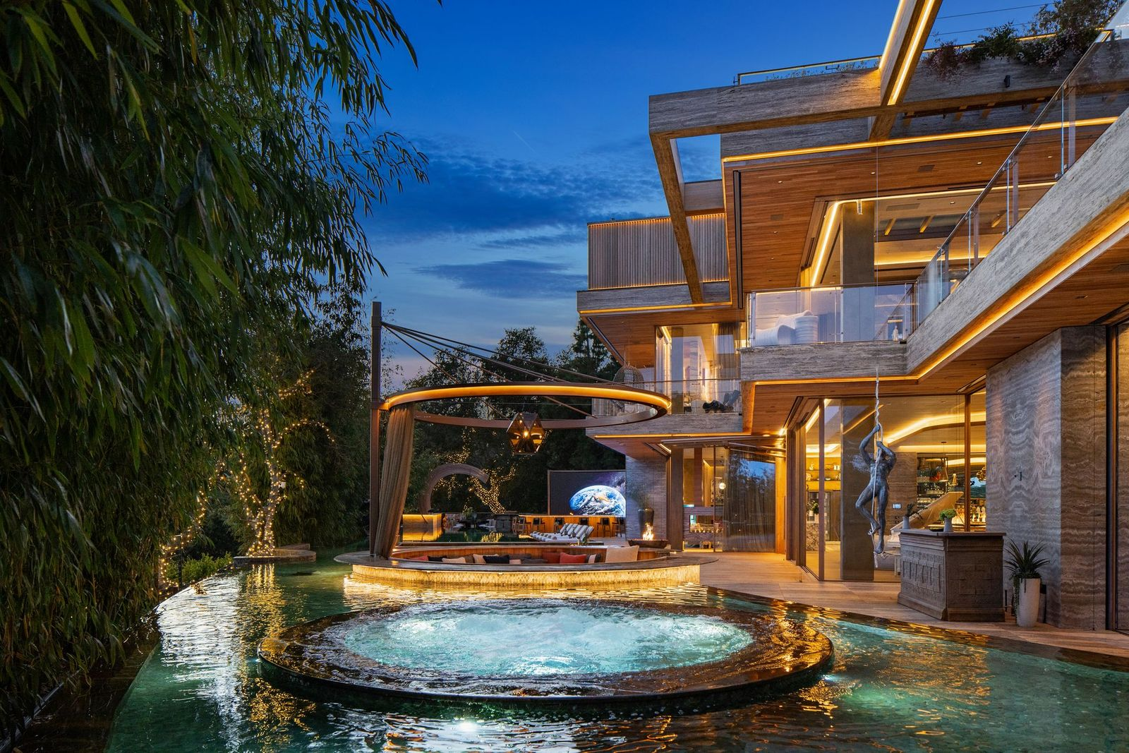 Split into two sections by a sunken lounge, the other end of the pool moves into a circular hot tub that sits directly within the pool's water.