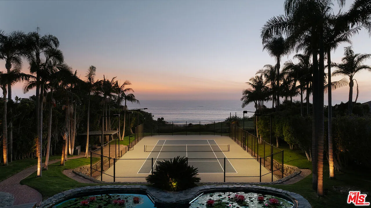 Positioned at the lowest point of the yard, the court takes full advantage of the elevated setting, with open ocean views stretching beyond the far fence.