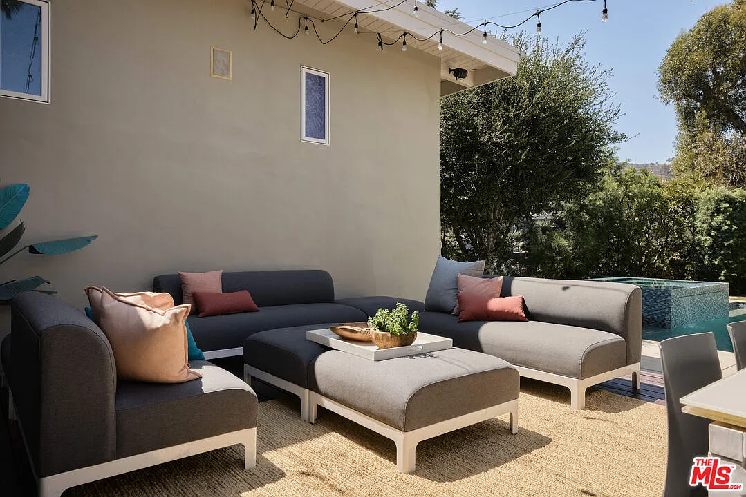 Grey outdoor lounge beneath string lights.