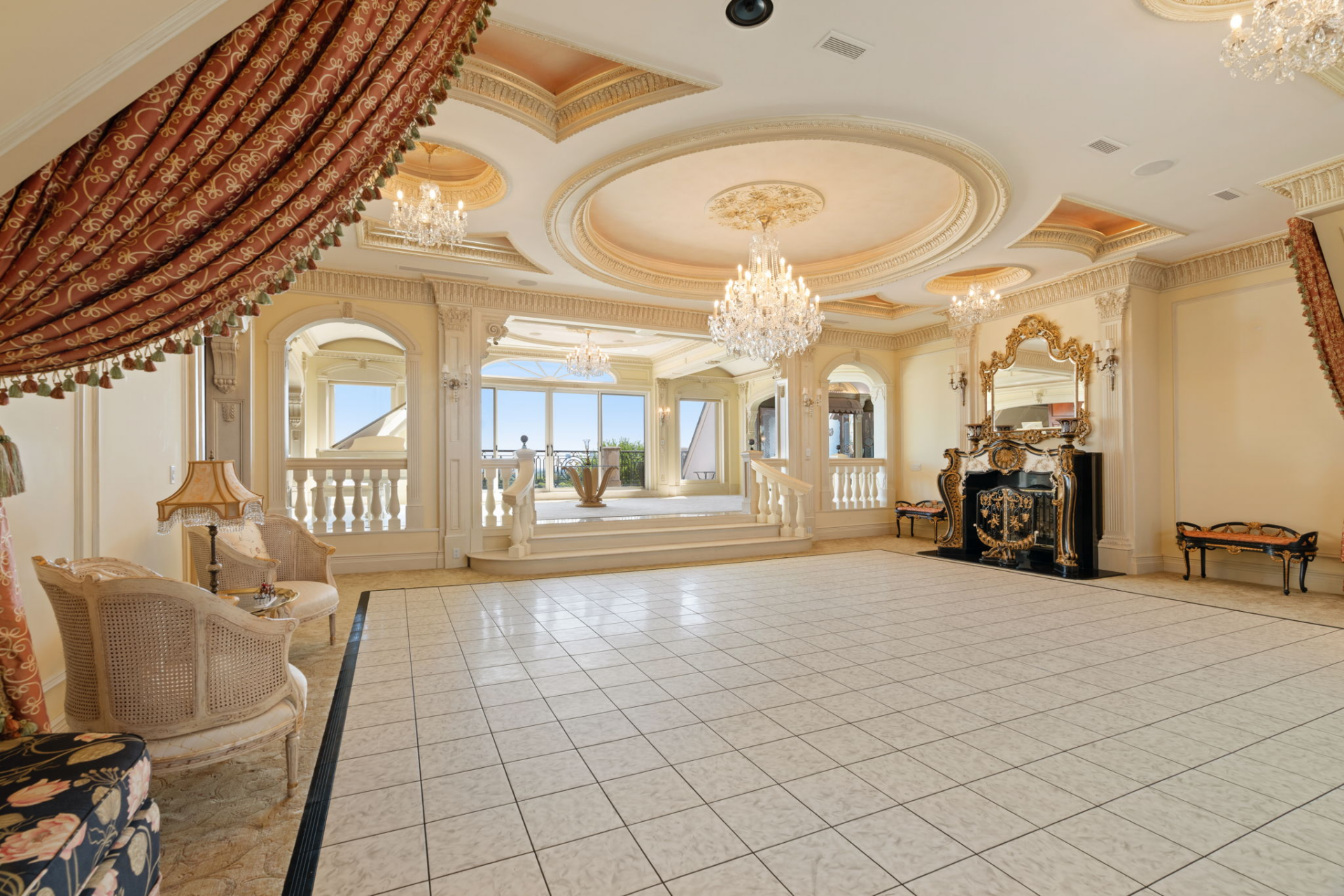 The level begins in the grand ballroom, a space framed by cream-colored walls, multiple crystal chandeliers, and a series of circular and recessed ceiling designs overhead.