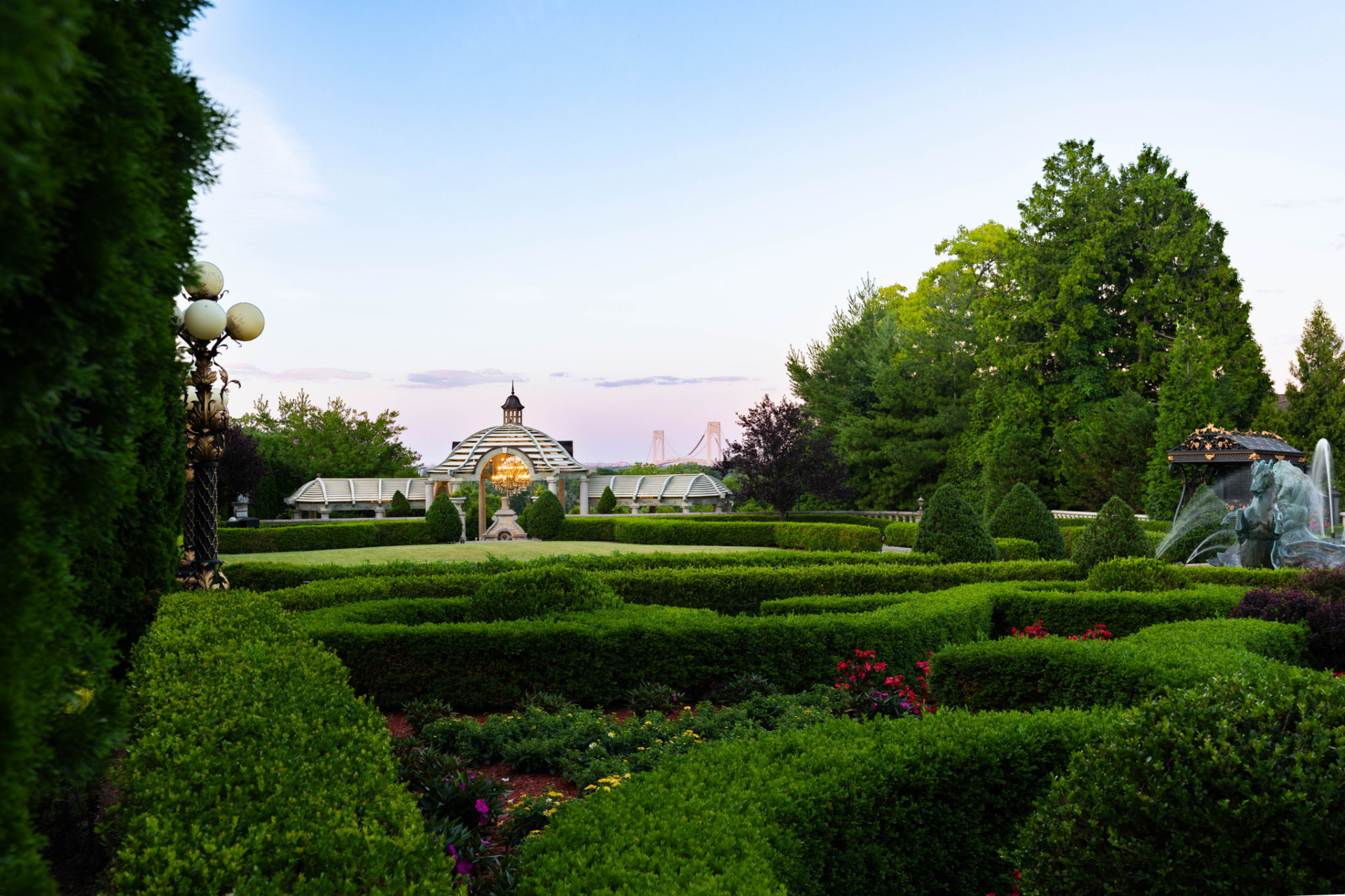 Right past the gardens, the pathways continue toward a separate gathering area positioned near the edge of the property.