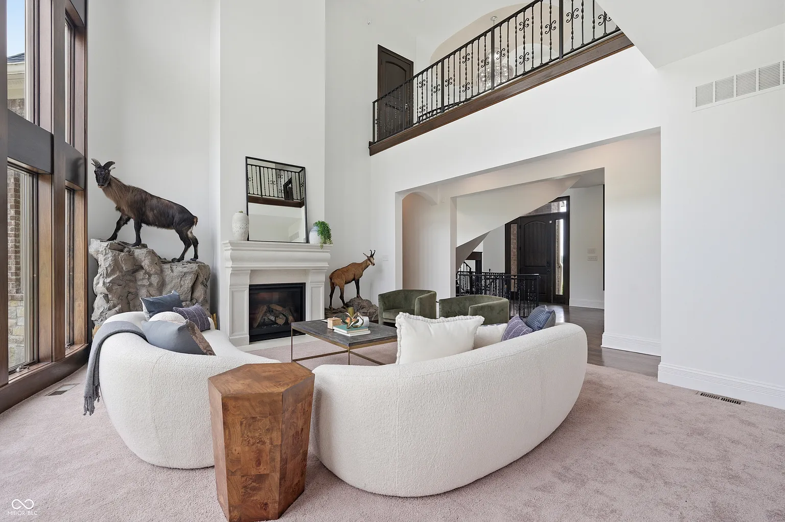 Rather than leading into a closed foyer, the layout keeps the main level open, with the living room positioned straight ahead.
