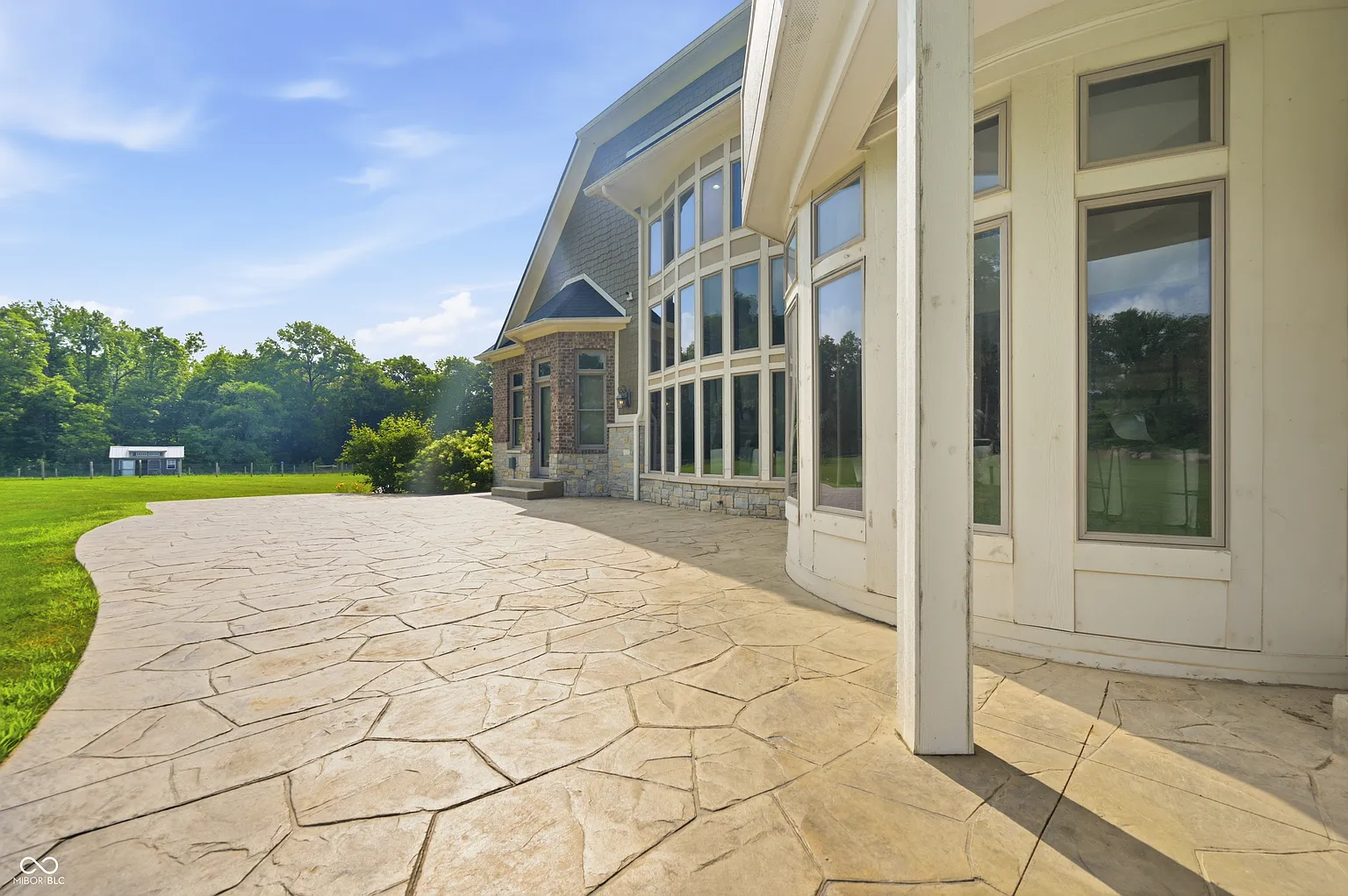 From the lower level, doors open directly onto a walkout patio that runs along the back of the house.