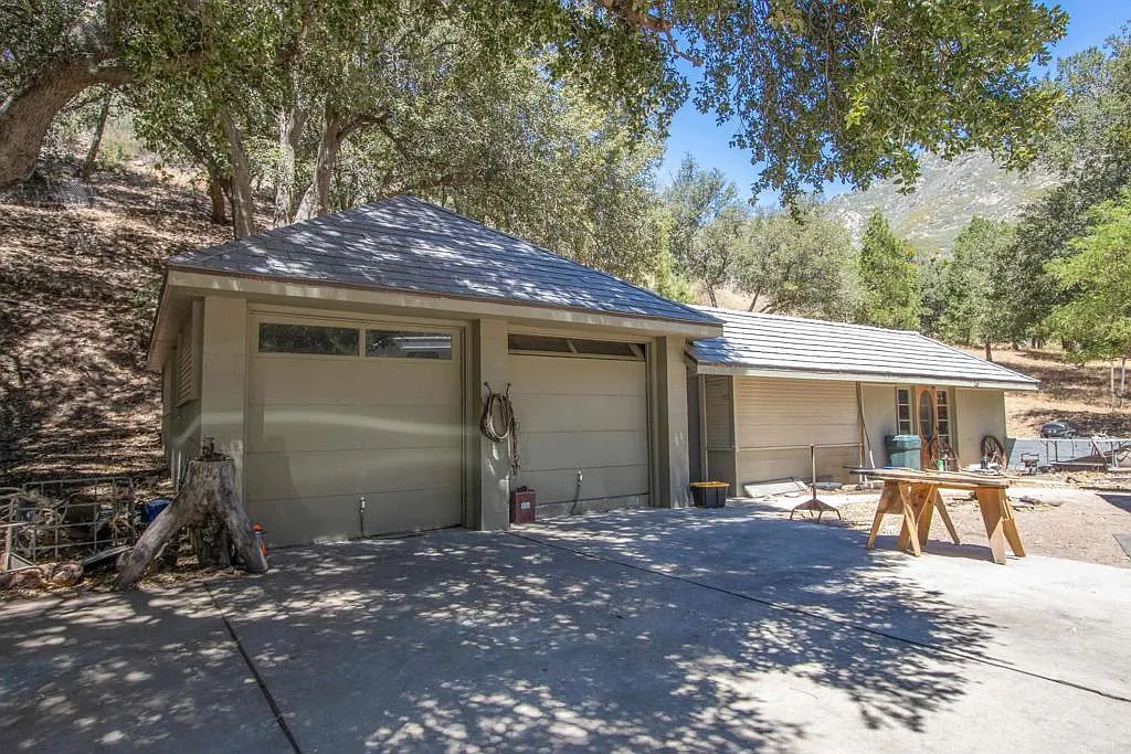 The property also includes a detached two-car garage paired with an adjoining bunk house.