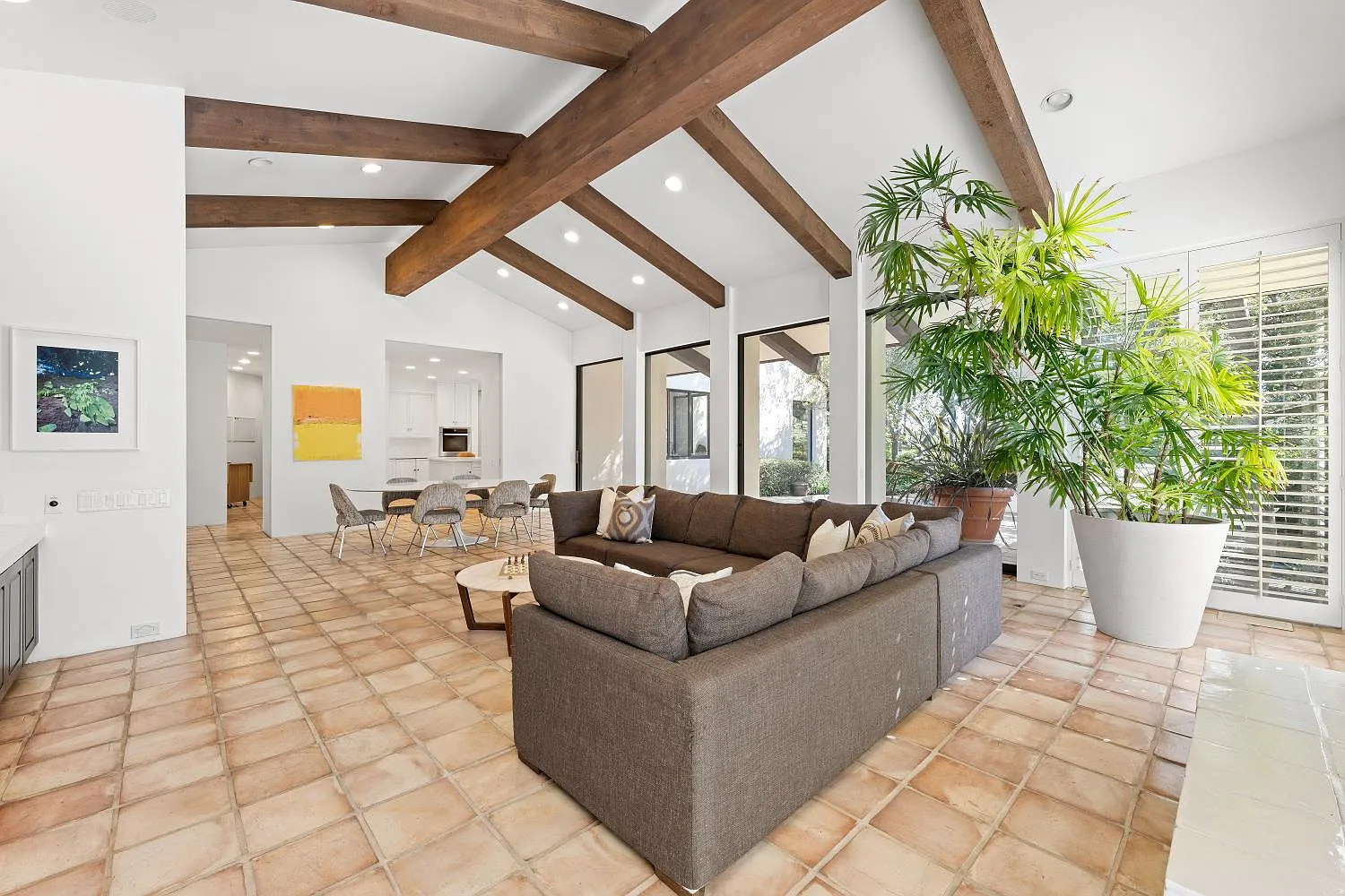 Just past the kitchen, the home opens into a large family room where a media area and casual dining space share one vaulted ceiling.