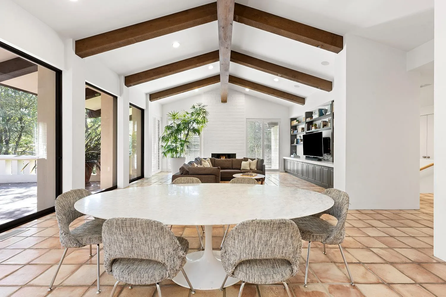 At the other end of the room, a round dining table creates a casual place to eat just steps from the kitchen.