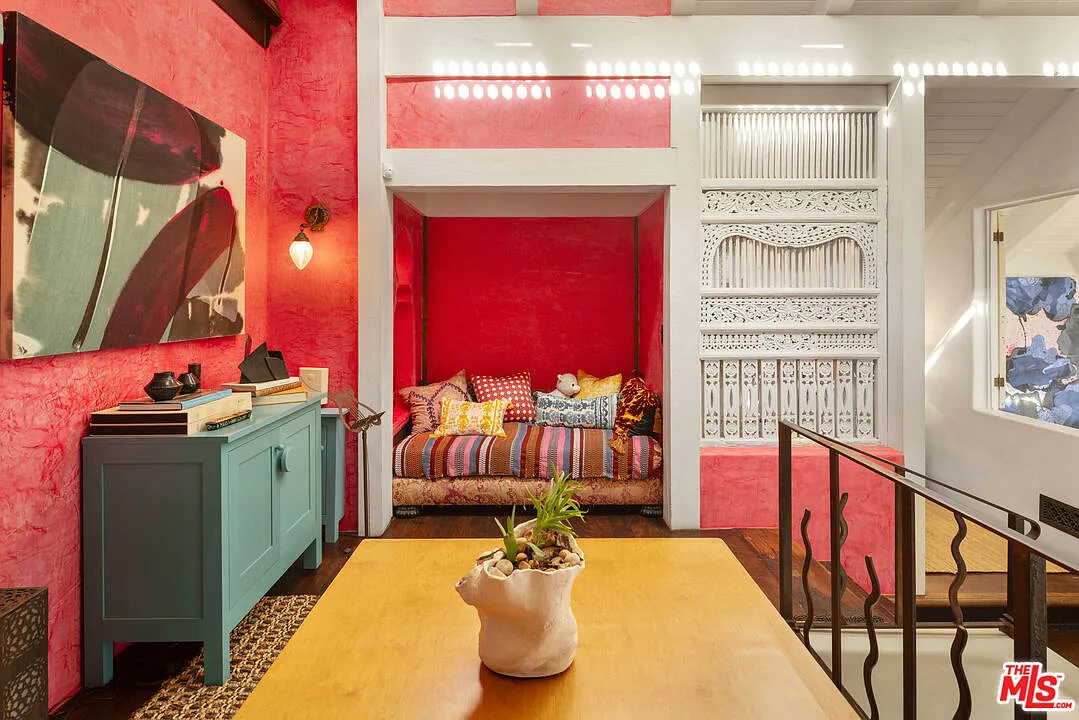 At the far end, the library opens into a private reading nook tucked into a deep wall recess. 