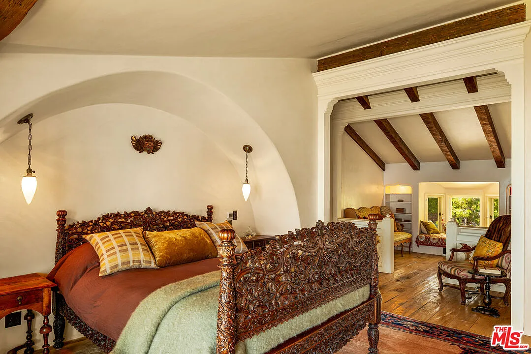The suite extends into its own reading nook with built-in shelving and built-in window seat.