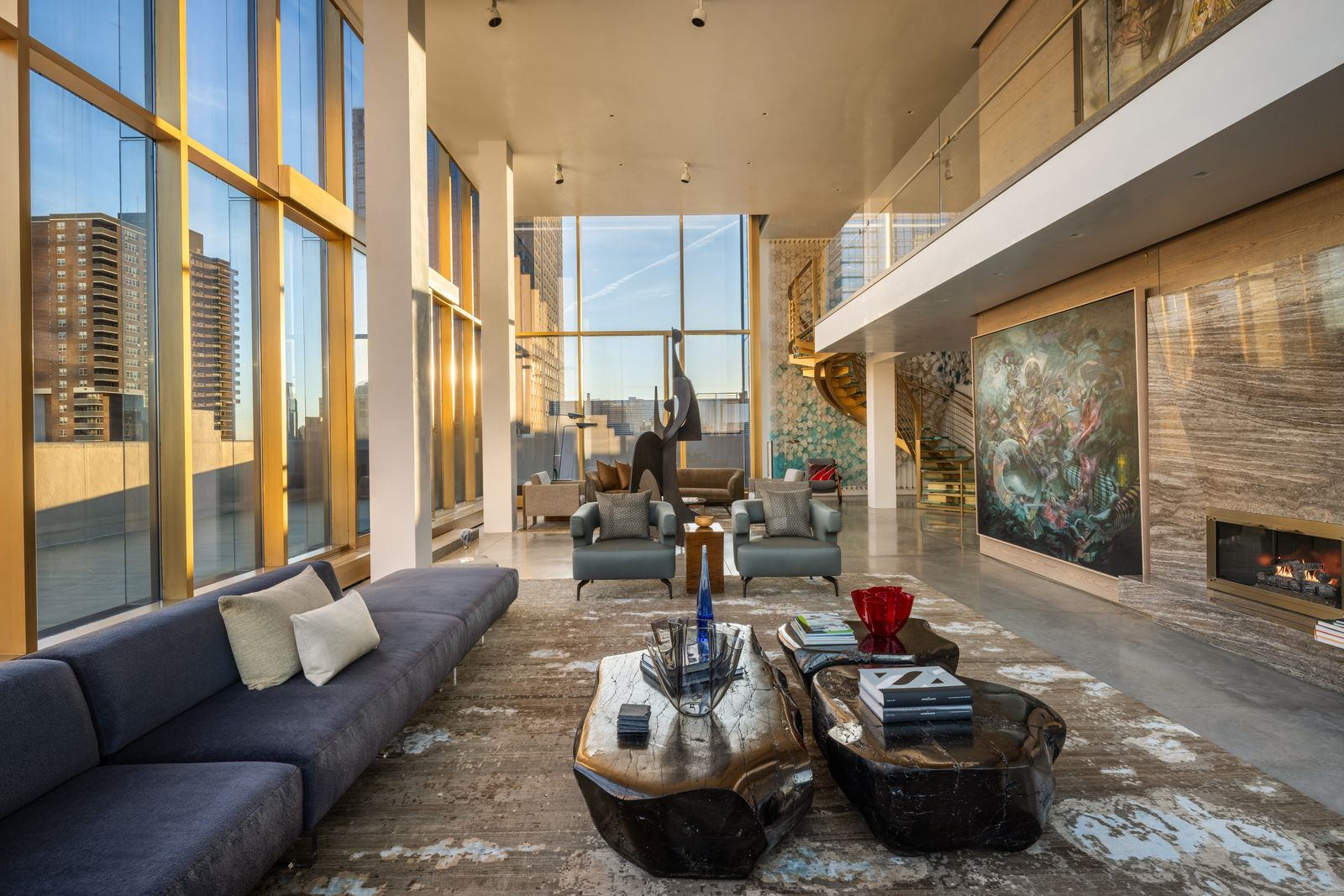A two-story cerused oak and silver travertine fireplace sits on one side, while oversized sliding glass walls connect nearly every room to the expansive wraparound terrace.