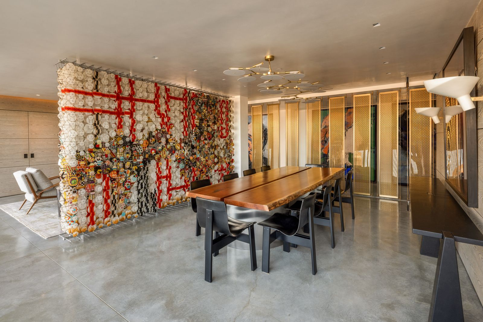 The formal dining room centers on a live-edge wood table surrounded by smooth black chairs.