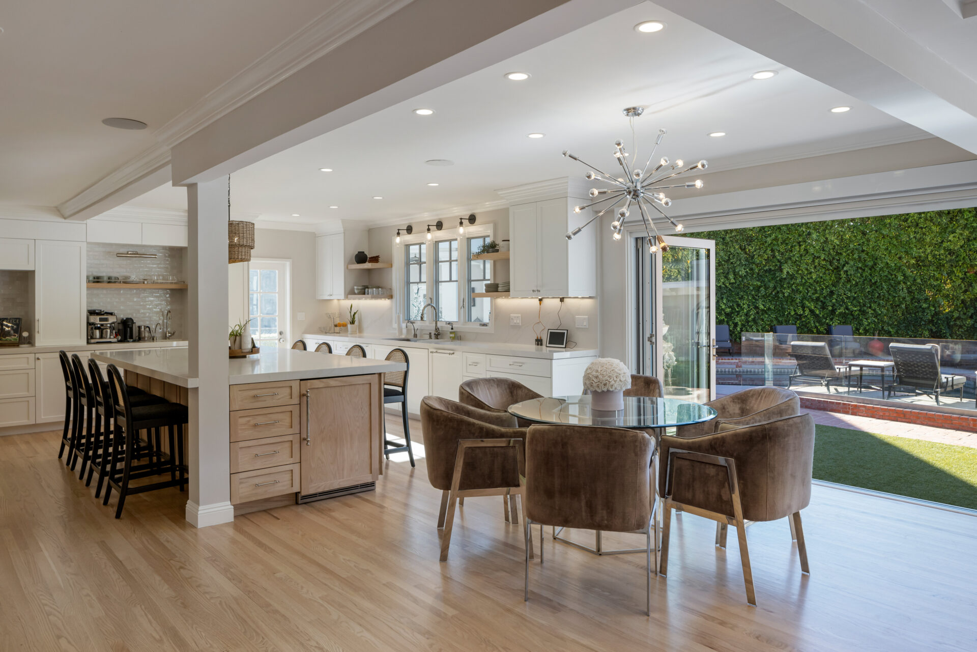 The kitchen opens around a large center island with bartop seating lining both sides.
