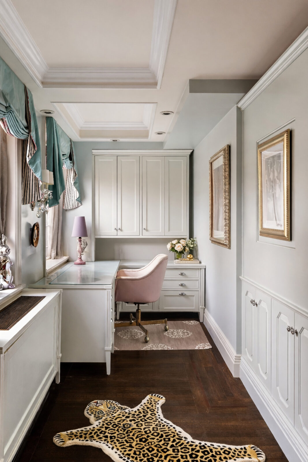The home office sits in a narrow window-lined space with a built-in desk running beneath the windows. 
