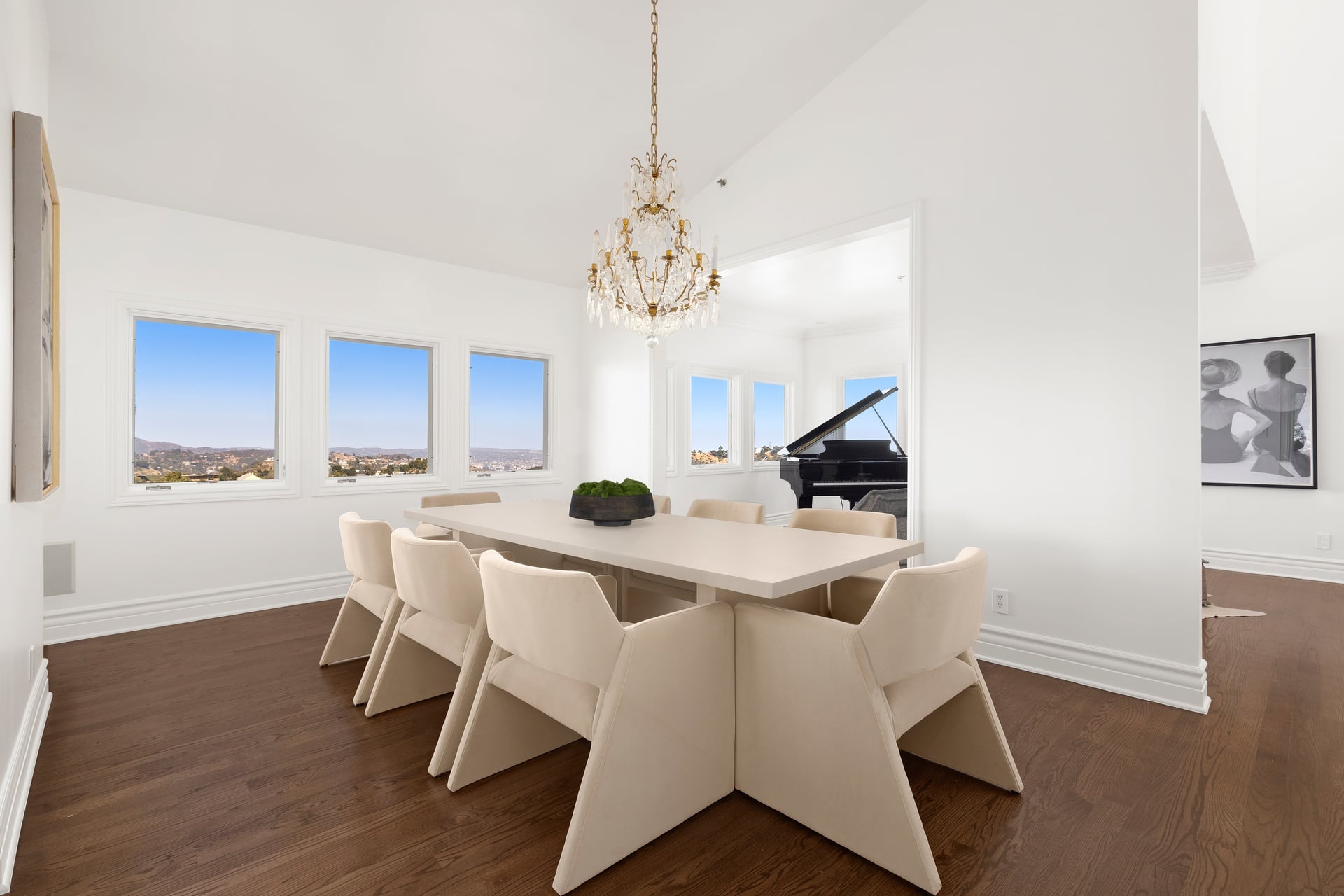A separate formal dining room rises beneath a 15-foot ceiling, with a large rectangular table centered beneath a crystal chandelier. 