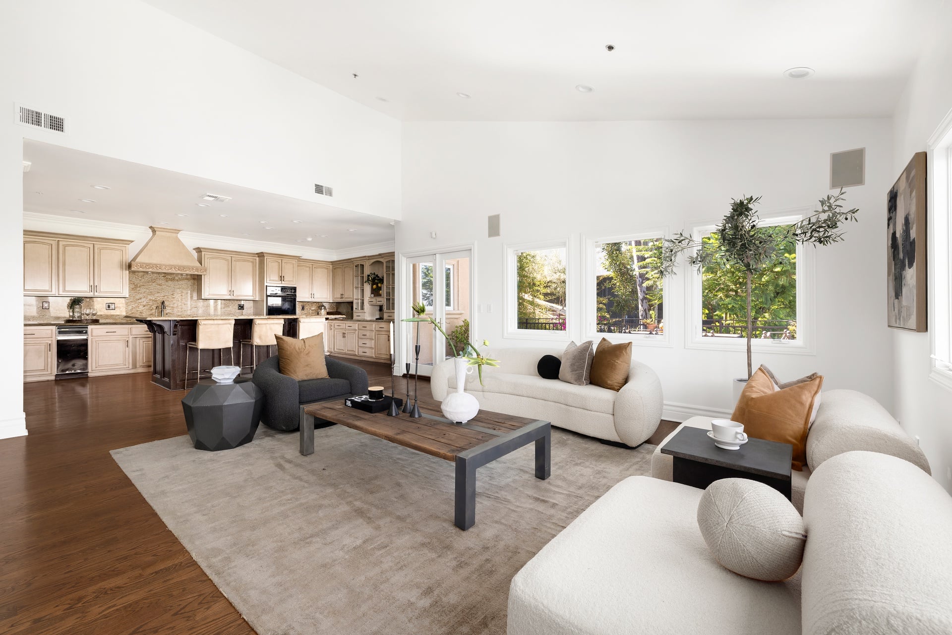 The family room opens directly into the Mediterranean-style kitchen, where a large marble island provides casual dining space. 