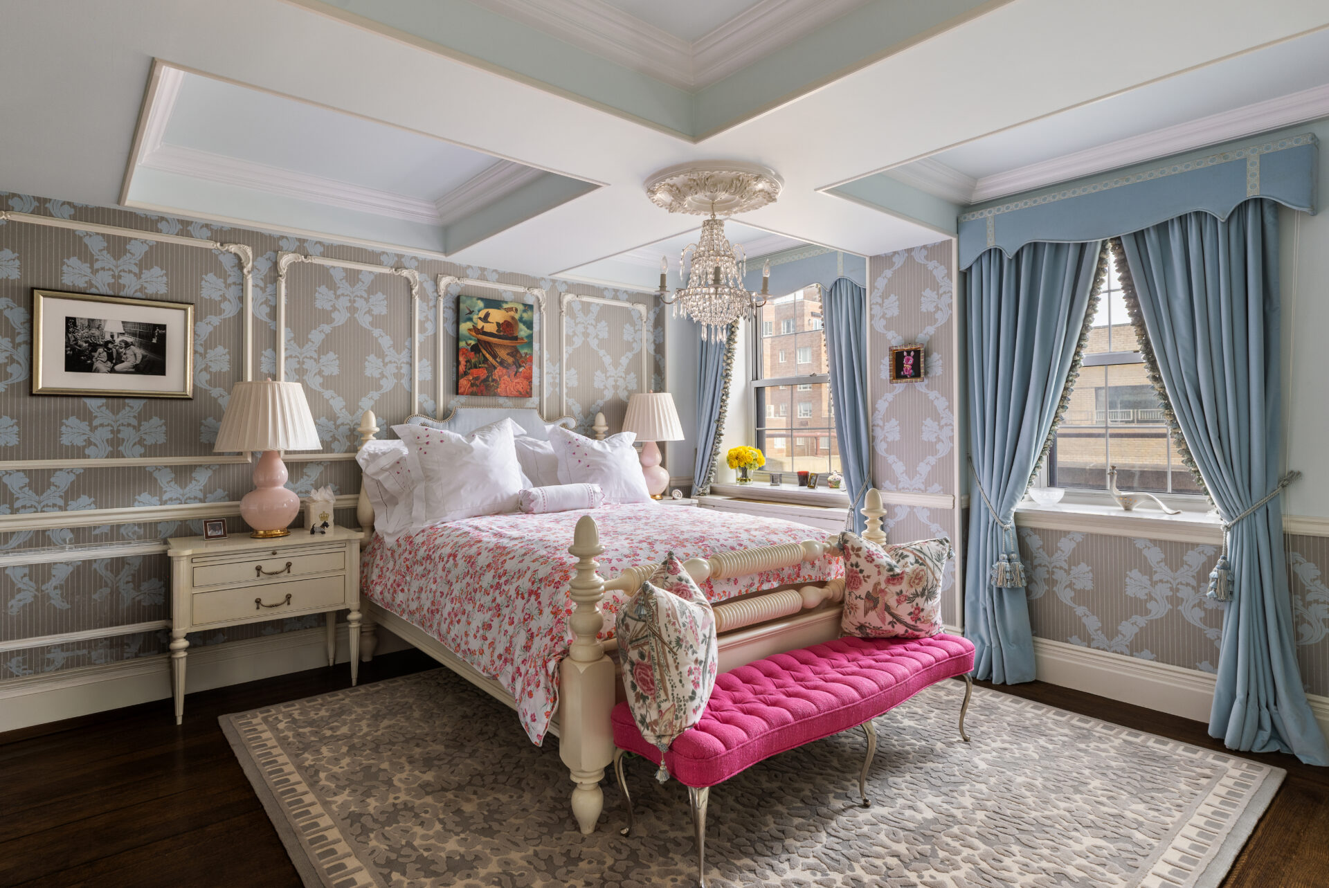 The bedroom suite with Lee Jofa wallpaper wrapping the room beneath a coffered ceiling and pale blue drapery framing the windows.