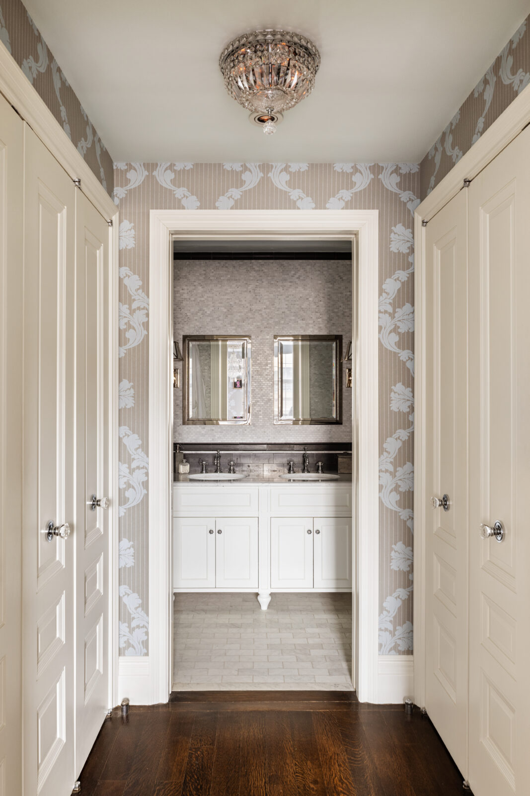 A dressing room lined with closets on both sides before opening into the suite's private bathroom.